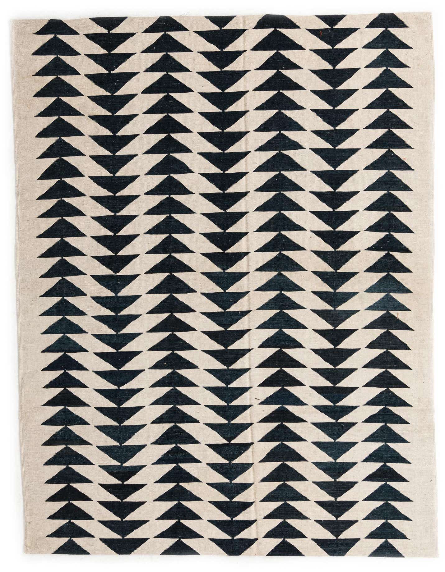 A 6x9 rectangular Kilim Modern rug with a bold black and ivory geometric tribal pattern, ideal for a living room.