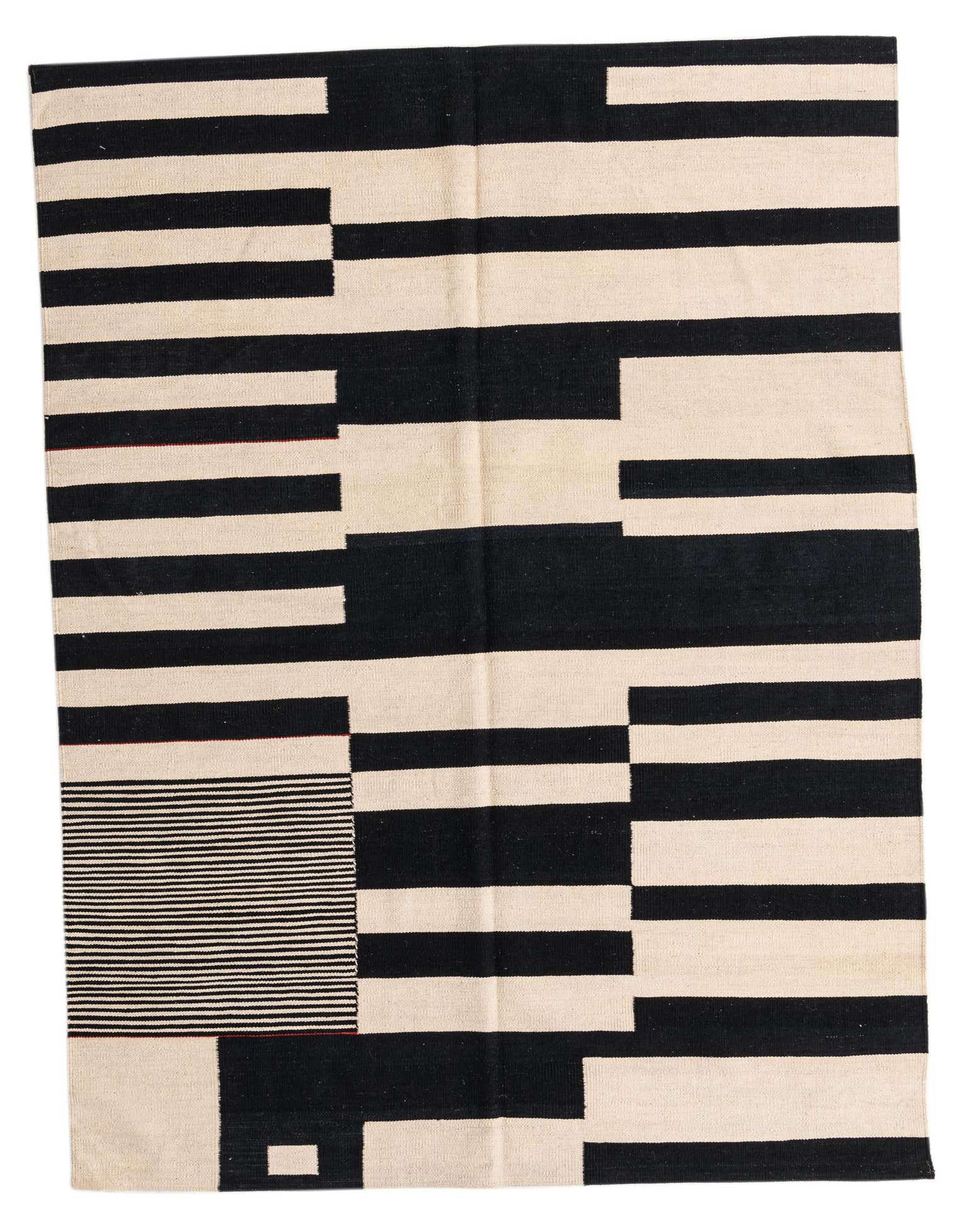 A 5x8 rectangular Kilim Modern rug with a bold black and cream geometric tribal pattern, handmade from wool.