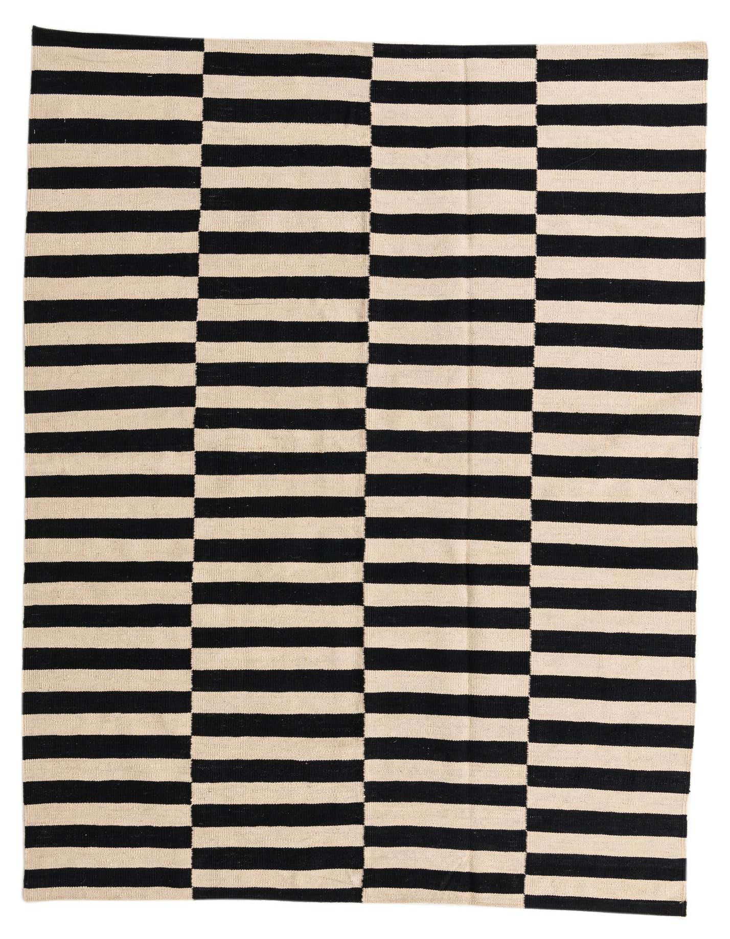 A 5x8 rectangular flatweave rug with a bold black and cream striped pattern, featuring alternating horizontal and vertical blocks.