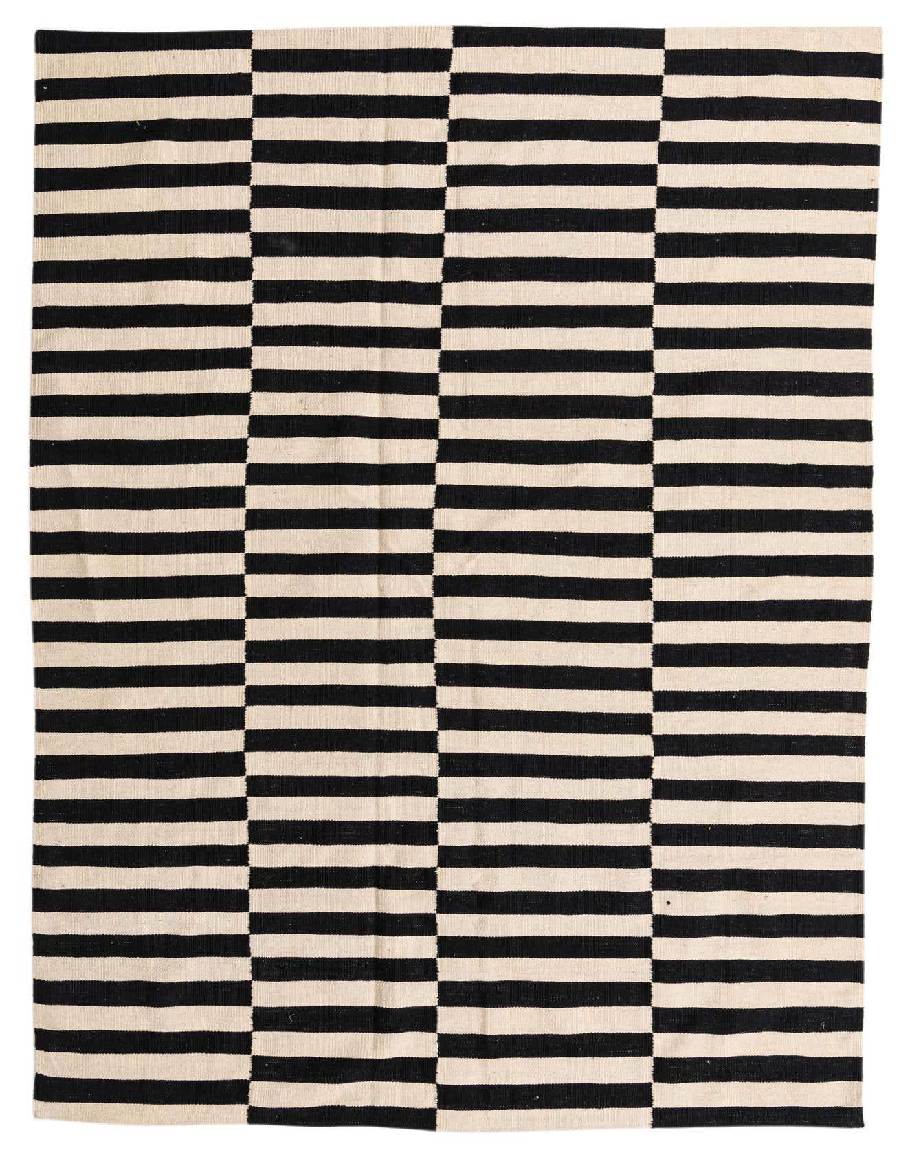 A 7x10 rectangular flatweave rug featuring a bold black and cream striped pattern, perfect for a living room.