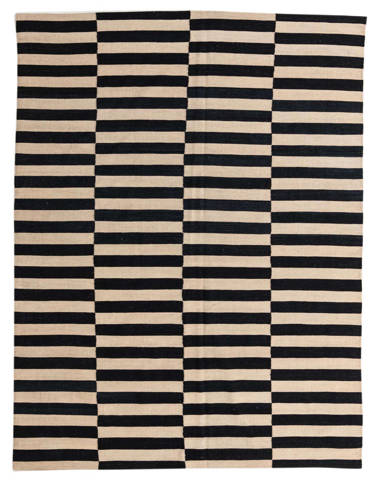A 7x10 rectangular flatweave rug featuring a bold black and cream striped pattern, perfect for a modern living room.