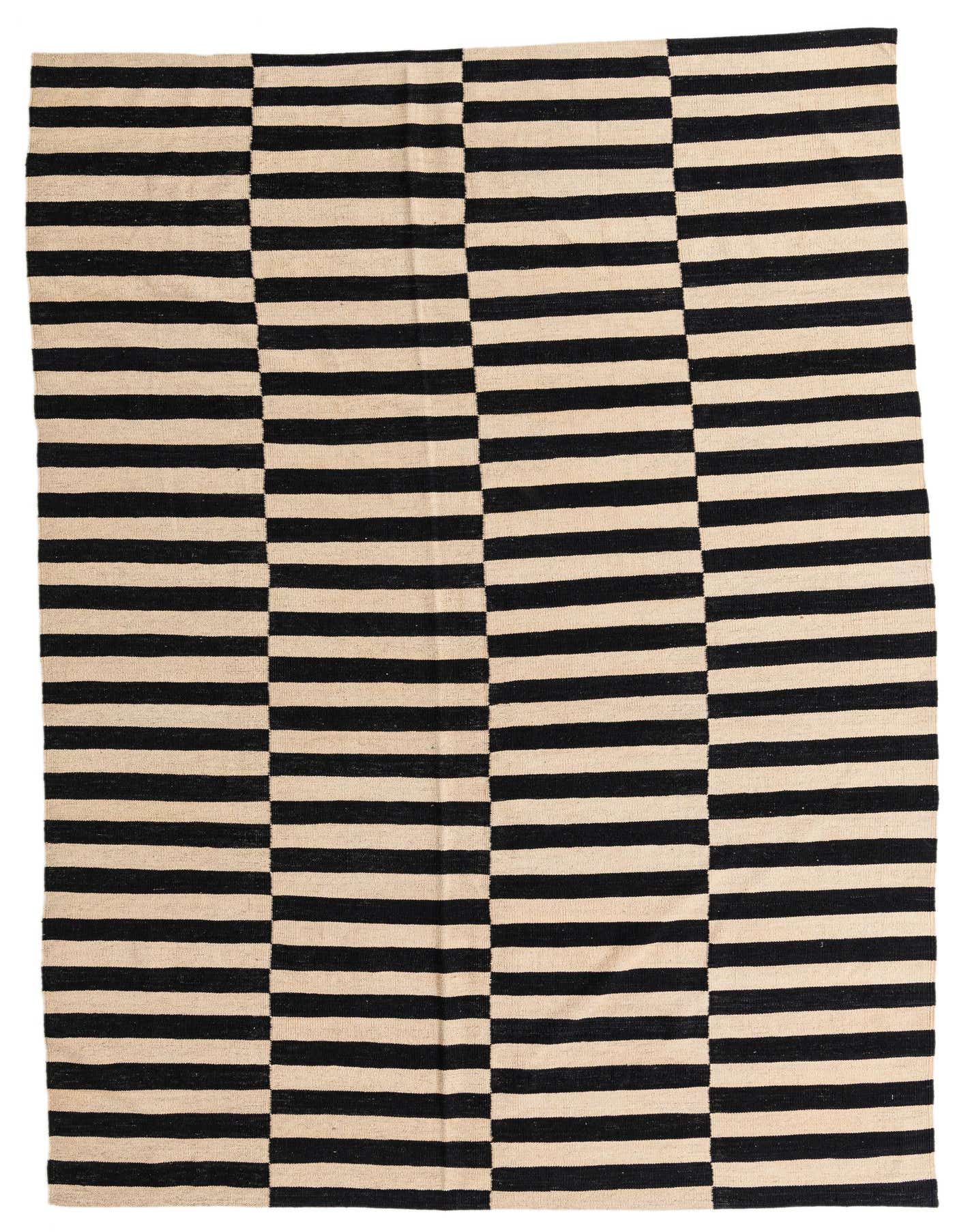 A 7x10 rectangular flatweave rug featuring a bold black and cream striped tribal pattern, perfect for a modern living room.
