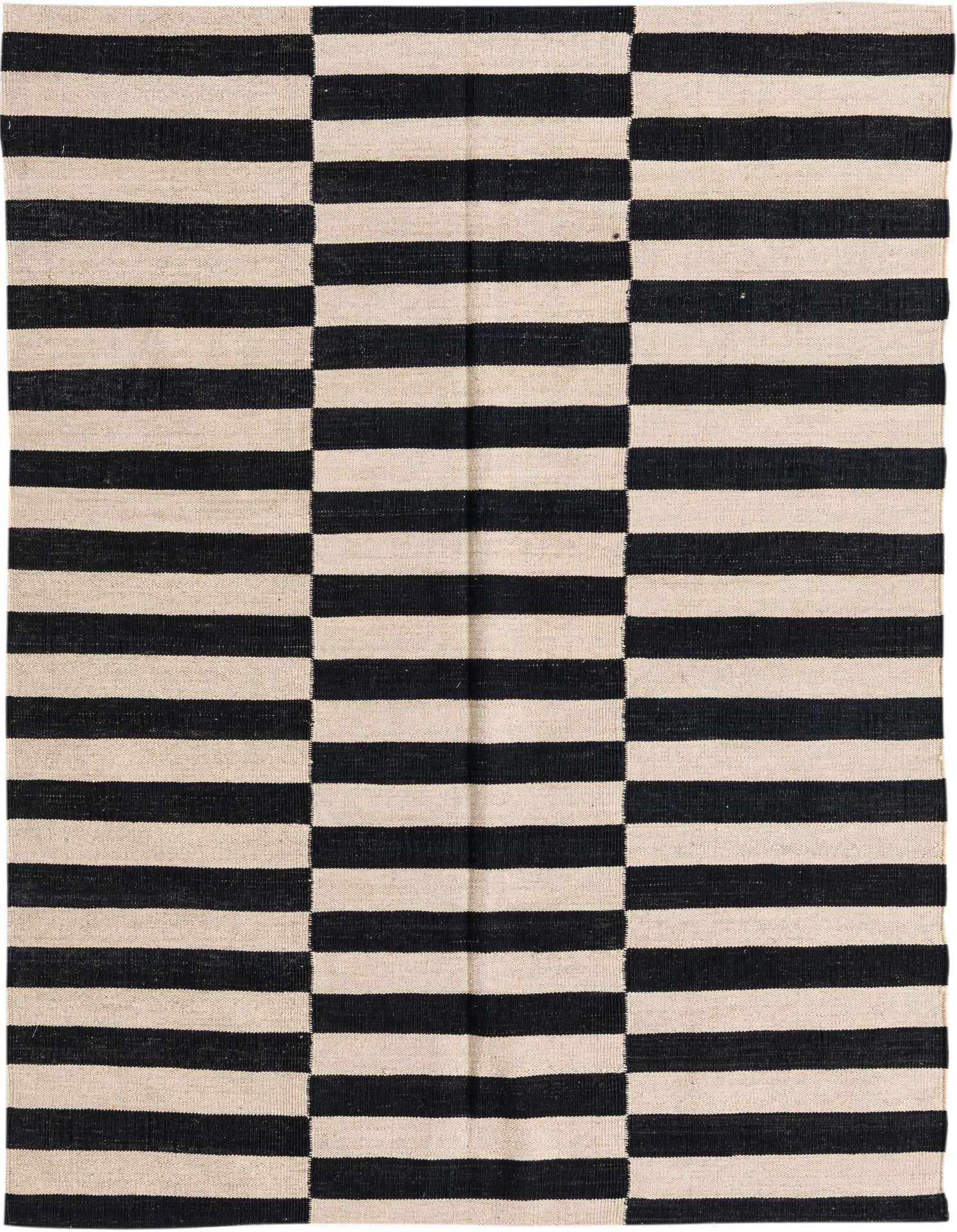 A 4x6 rectangular black and ivory flatweave wool rug with a bold striped tribal pattern.