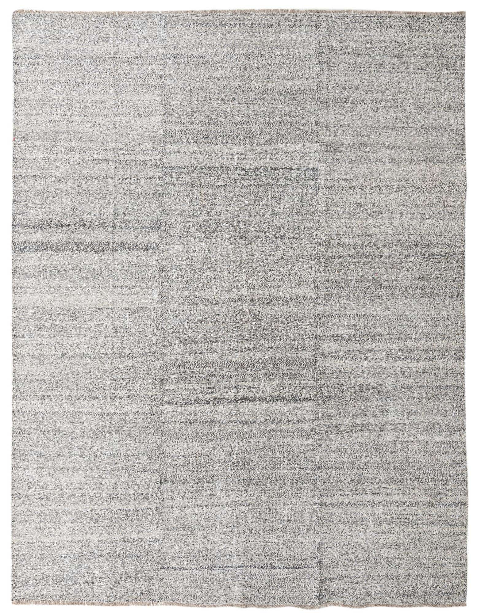 An 8x10 rectangular flatweave wool rug featuring a modern tribal pattern in shades of black, white, and ivory.