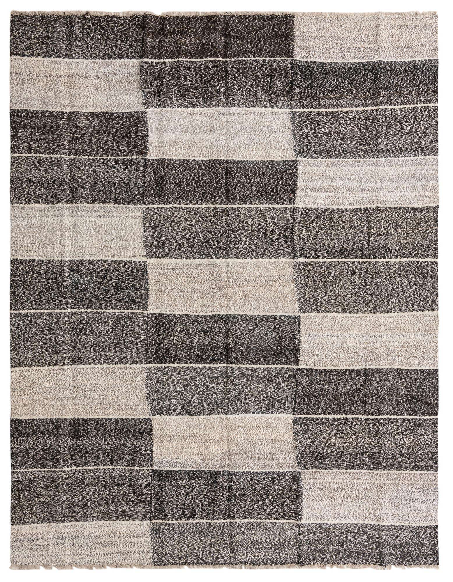 An 8x10 rectangular flatweave wool rug featuring a modern tribal pattern of alternating black and ivory horizontal blocks.