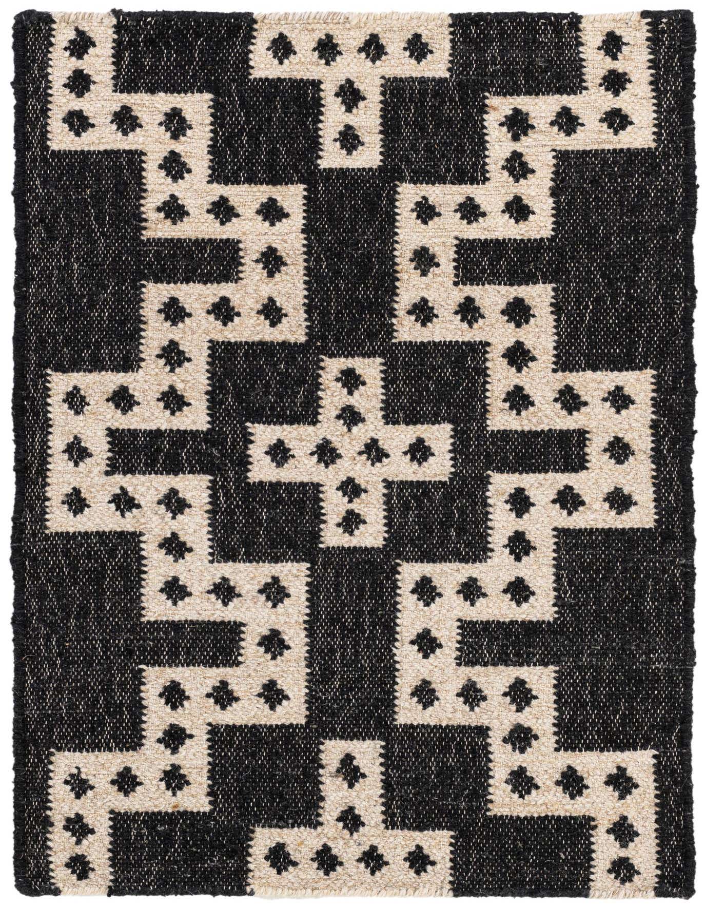 A 2x3 rectangular black and ivory Kilim wool rug with a bold tribal geometric pattern, suitable for an entryway.