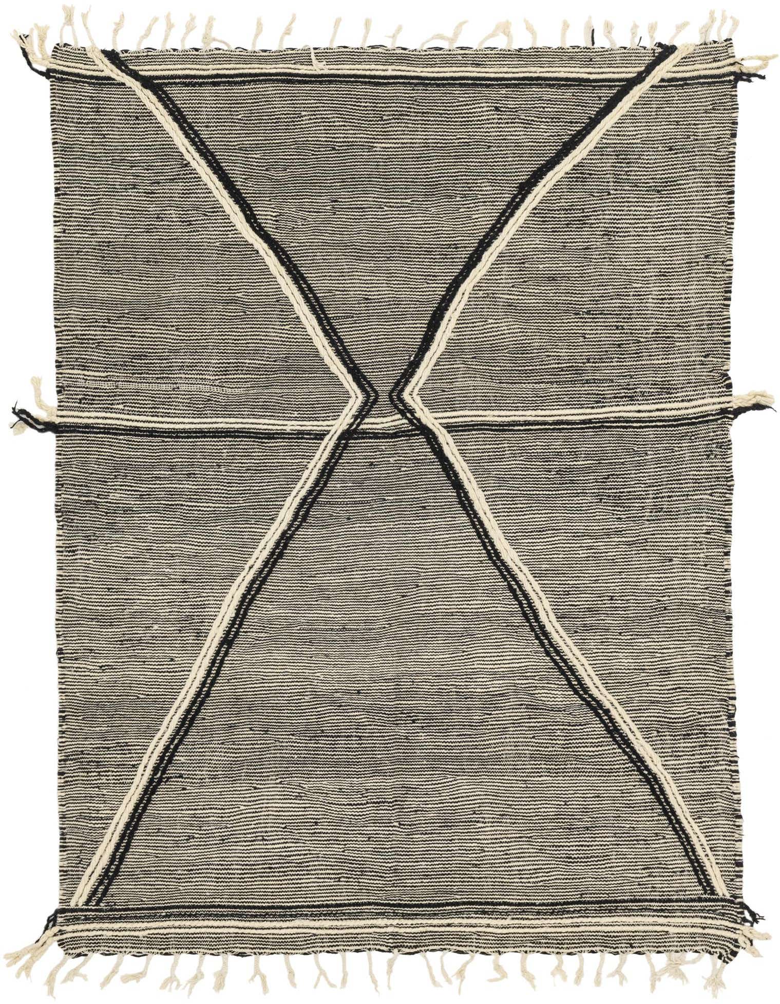 A 6x9 rectangular black and white tribal wool shag rug with an abstract geometric pattern and tassels.