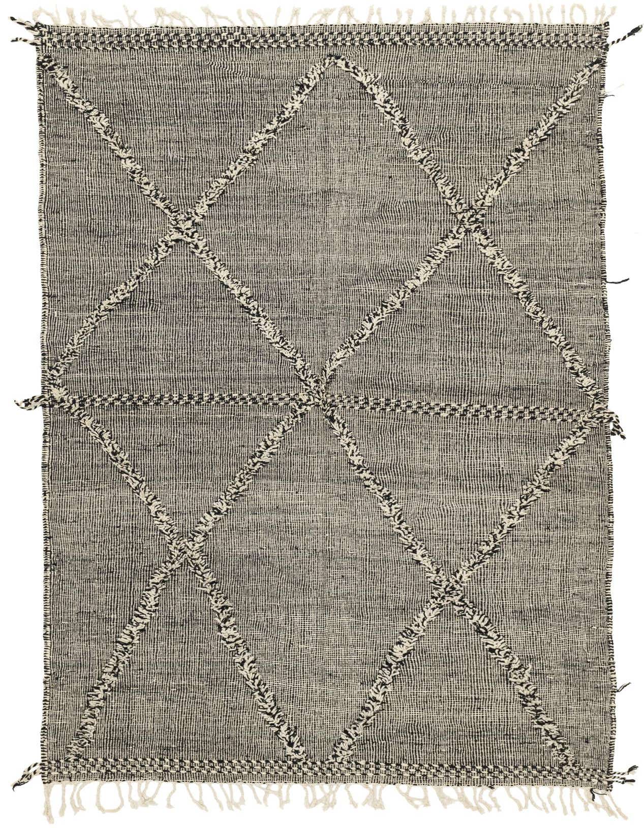 A 6x9 rectangular black and ivory tribal wool shag rug with a diamond pattern and fringe.