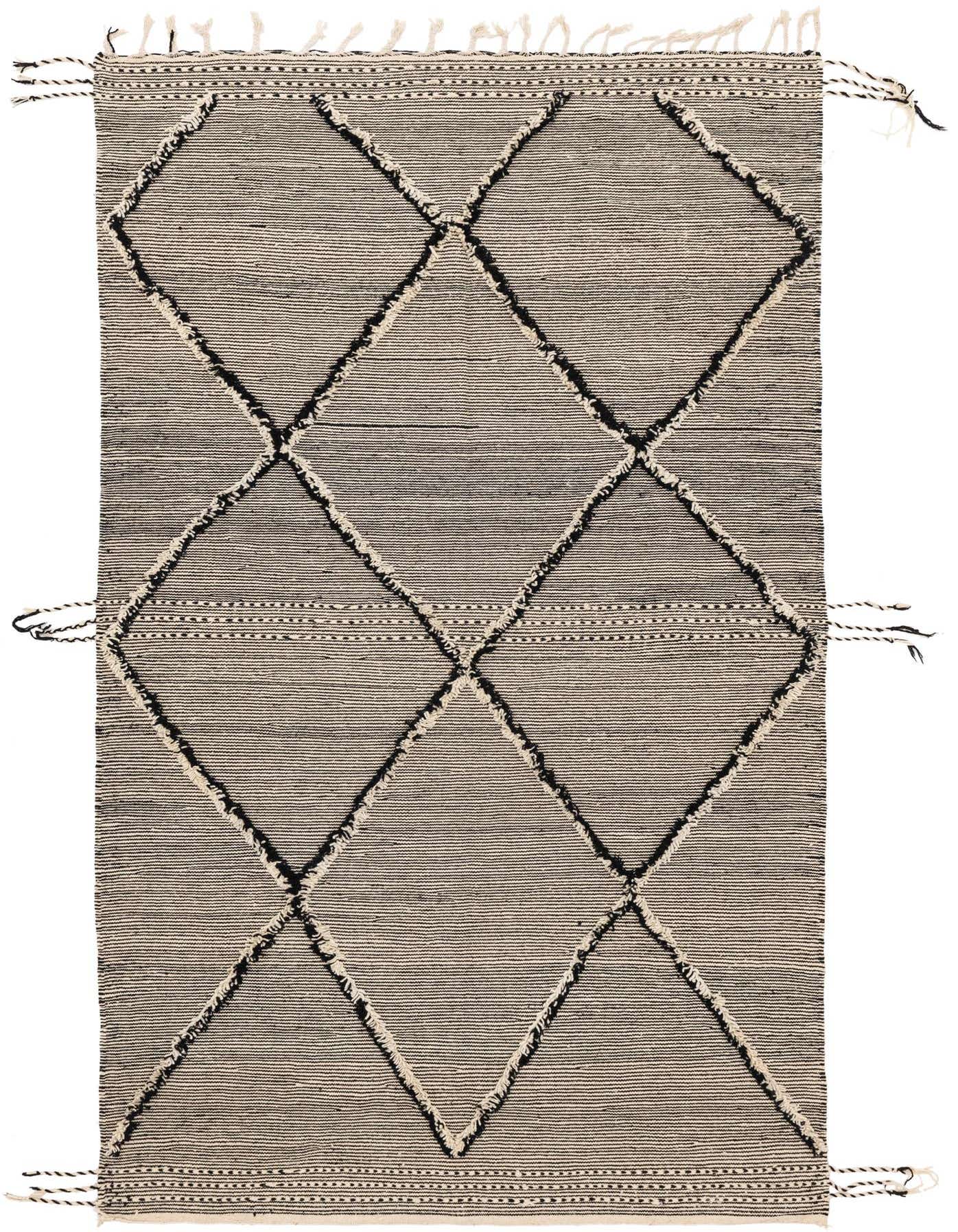 A 7x10 rectangular black and white wool shag rug with a bold tribal diamond pattern and decorative tassels.