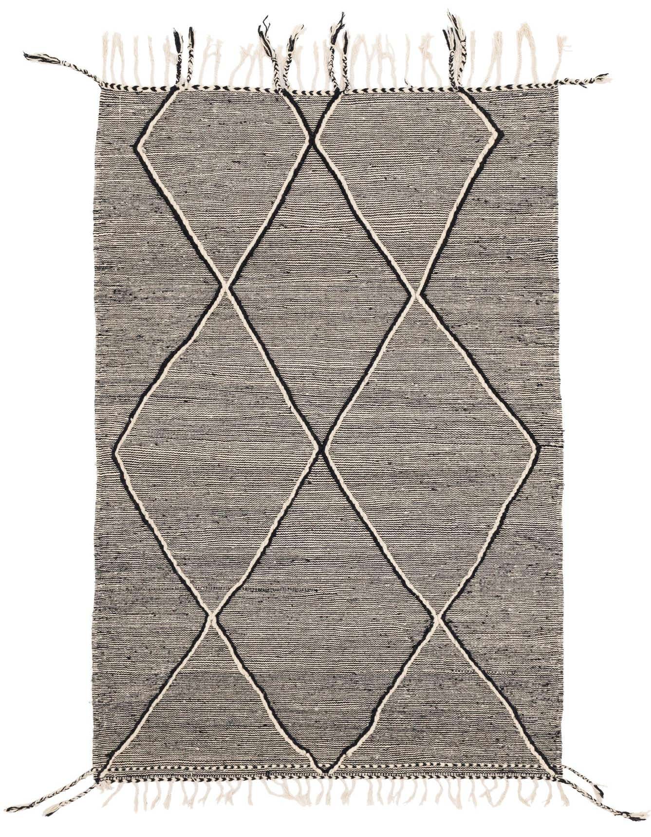 A 5x8 rectangular black and white tribal shag rug with a large diamond pattern and fringed edges.