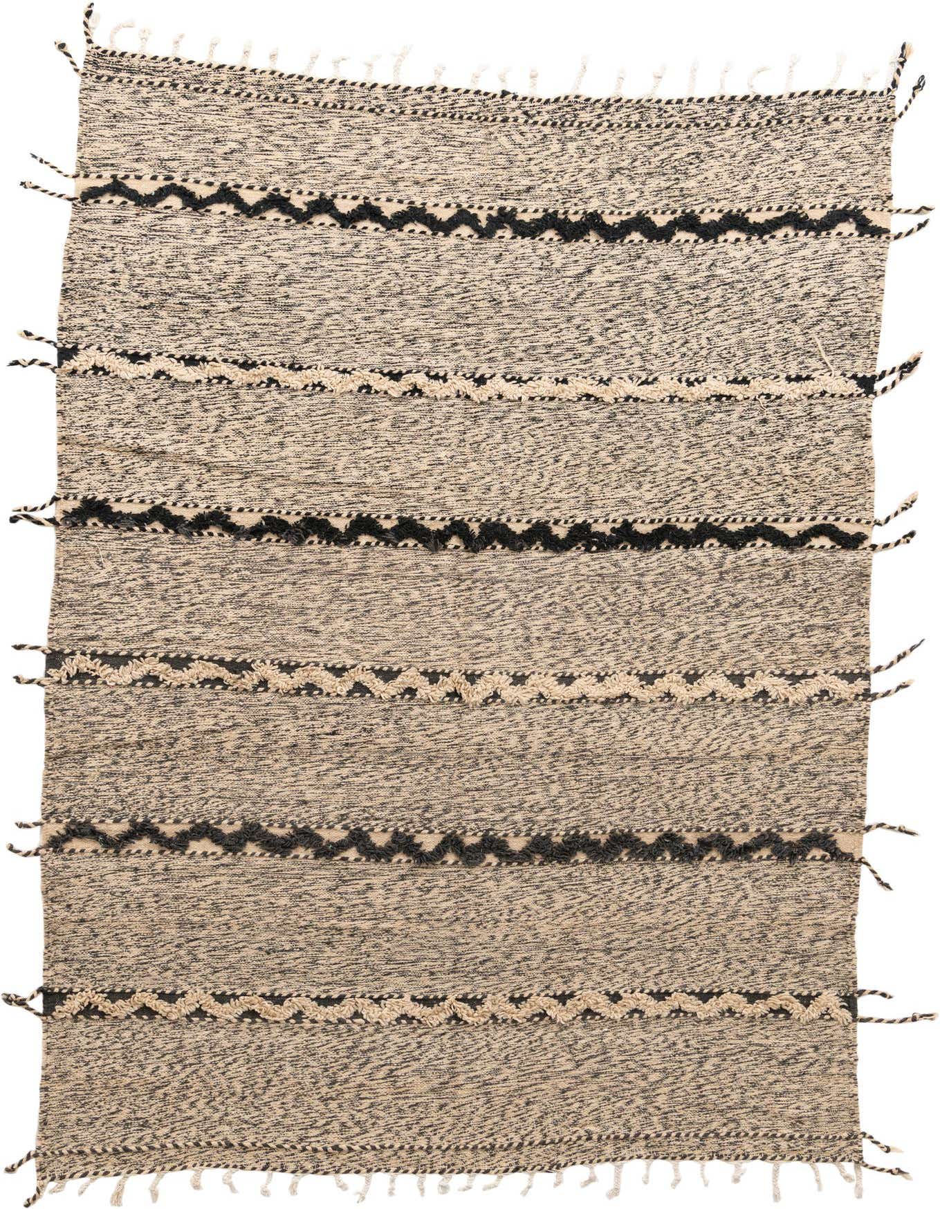 A 7x10 rectangular Moroccan shag rug in black and ivory with tribal zigzag patterns and tassels.