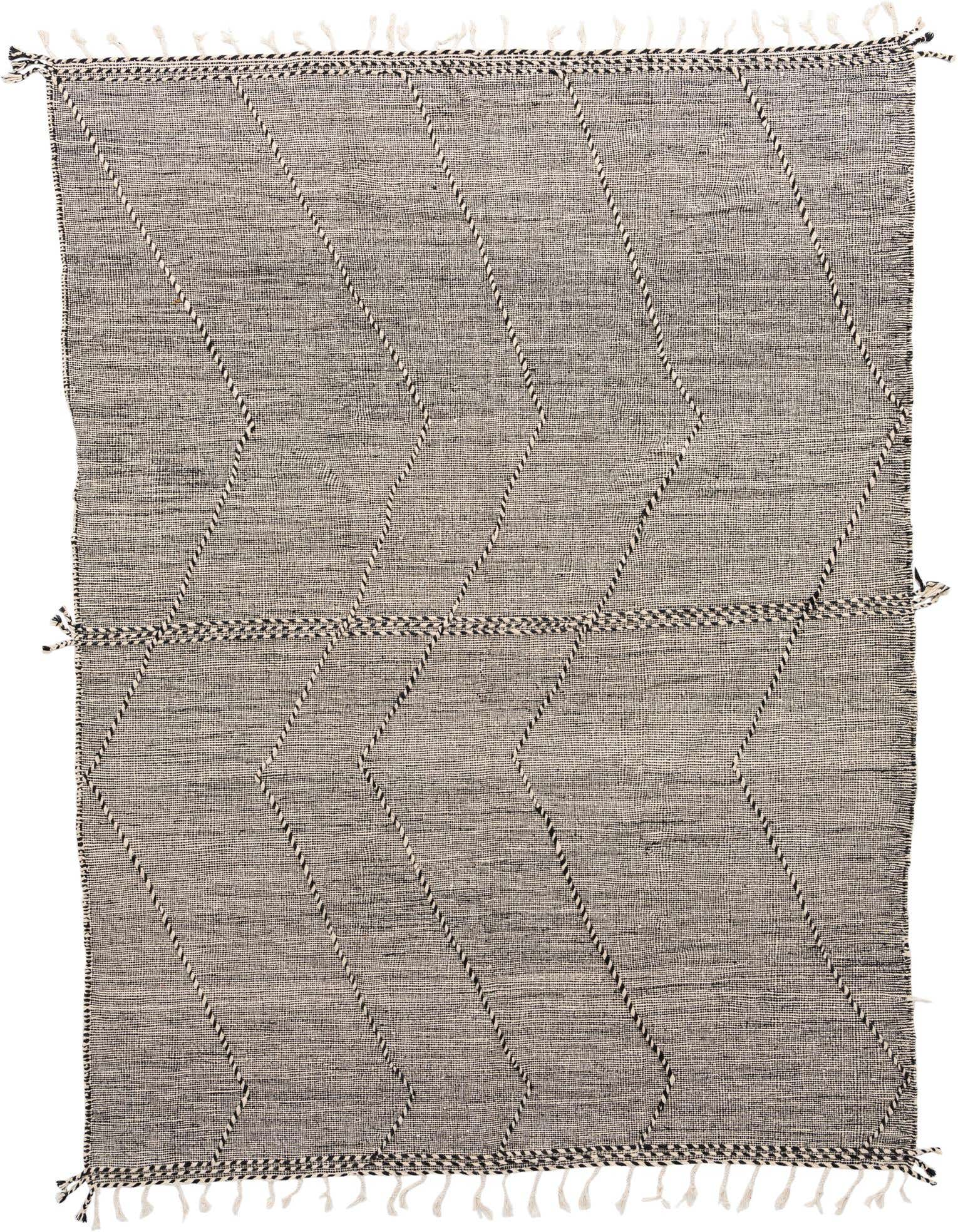 A 10x13 rectangular black and white wool shag rug with a tribal diamond pattern and fringe.