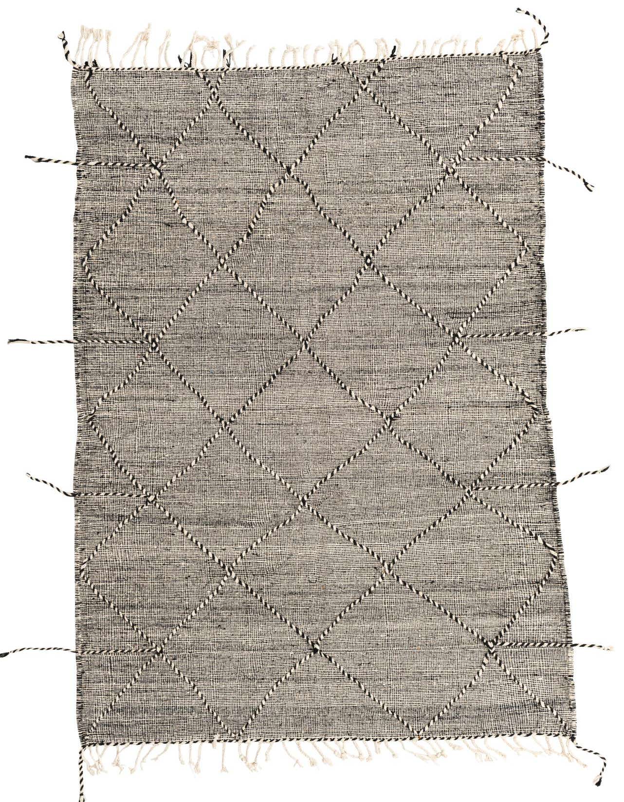 A 5x8 rectangular black and white tribal wool rug with a diamond pattern and fringe, suitable for a living room.