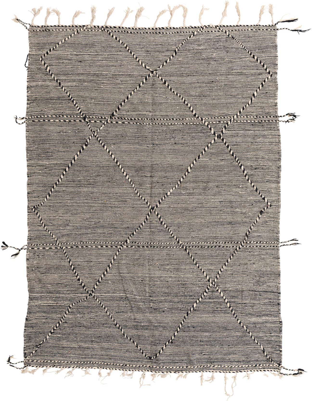 A 6x9 rectangular black and white tribal wool shag rug with a diamond pattern and fringe, suitable for a living room.