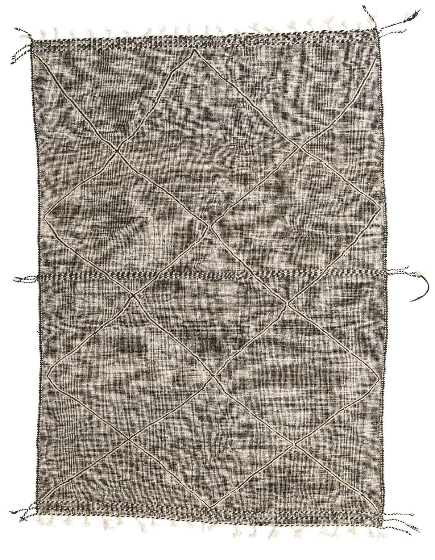 A 7x10 rectangular black and white tribal wool shag rug with a diamond pattern and fringe.