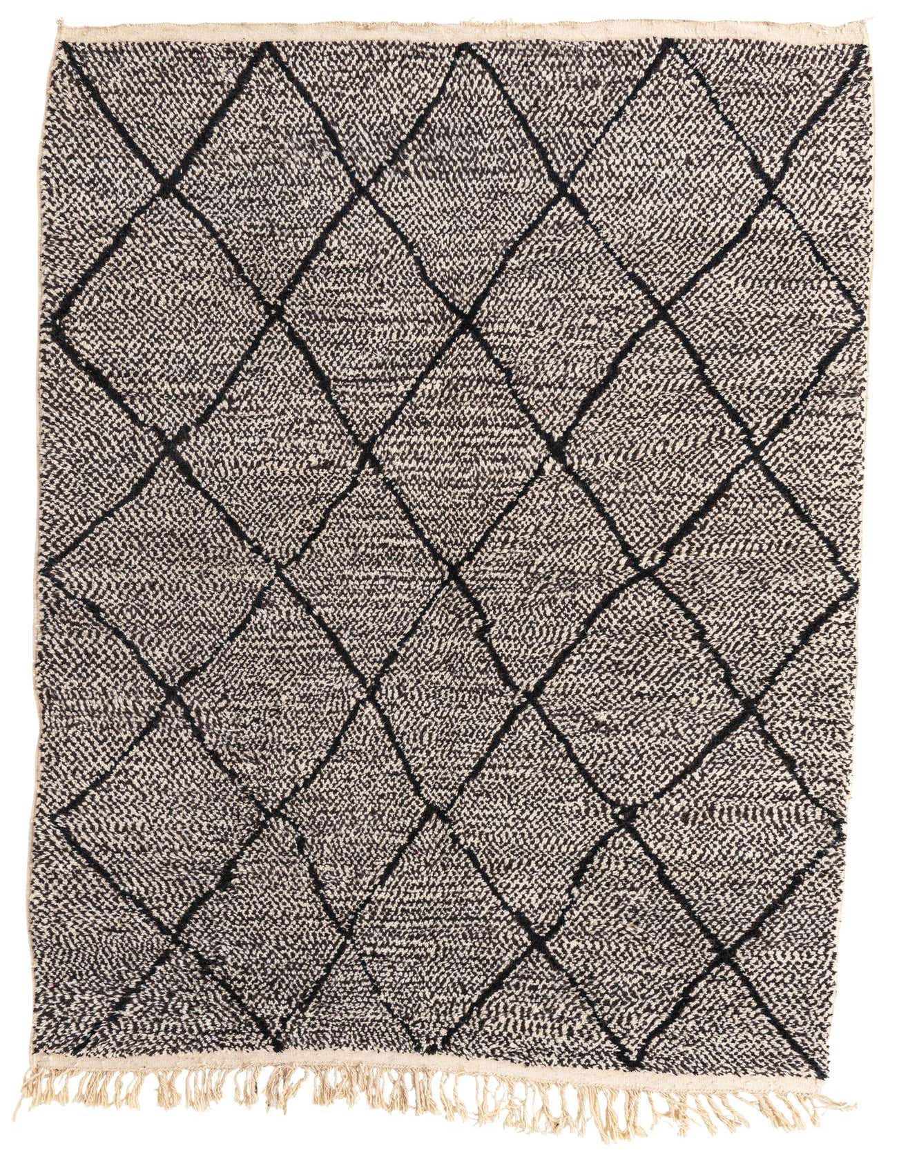 A 7x10 rectangular black and white Moroccan shag rug with a bold black diamond pattern and fringe.