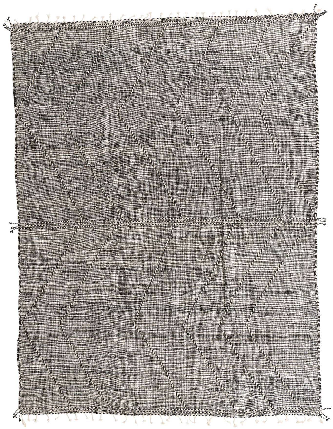 A 9x12 rectangular black and white tribal wool shag rug with a modern geometric pattern and tassels.