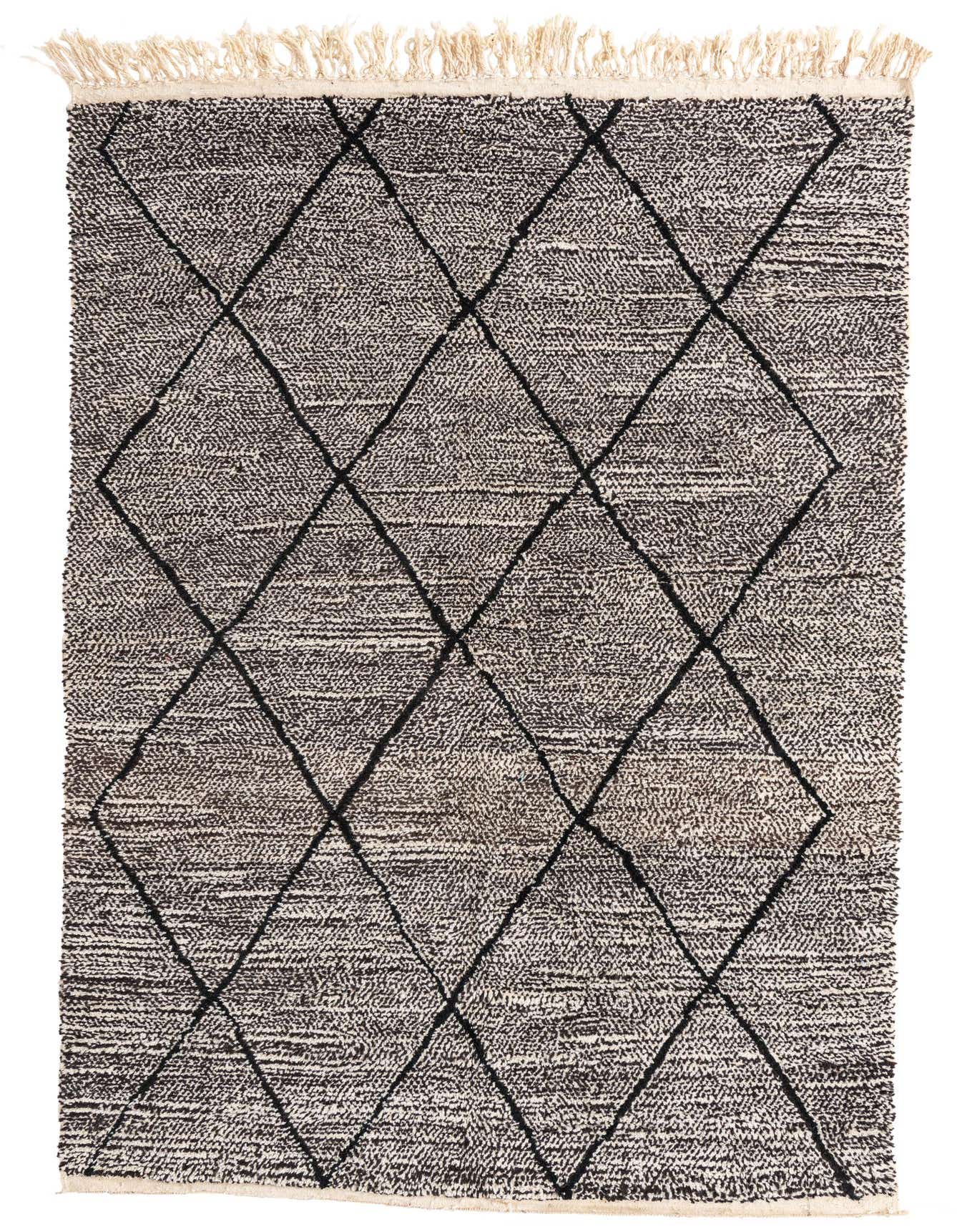 A 6x9 rectangular Moroccan shag rug in black and white with a bold diamond pattern and fringed edges.