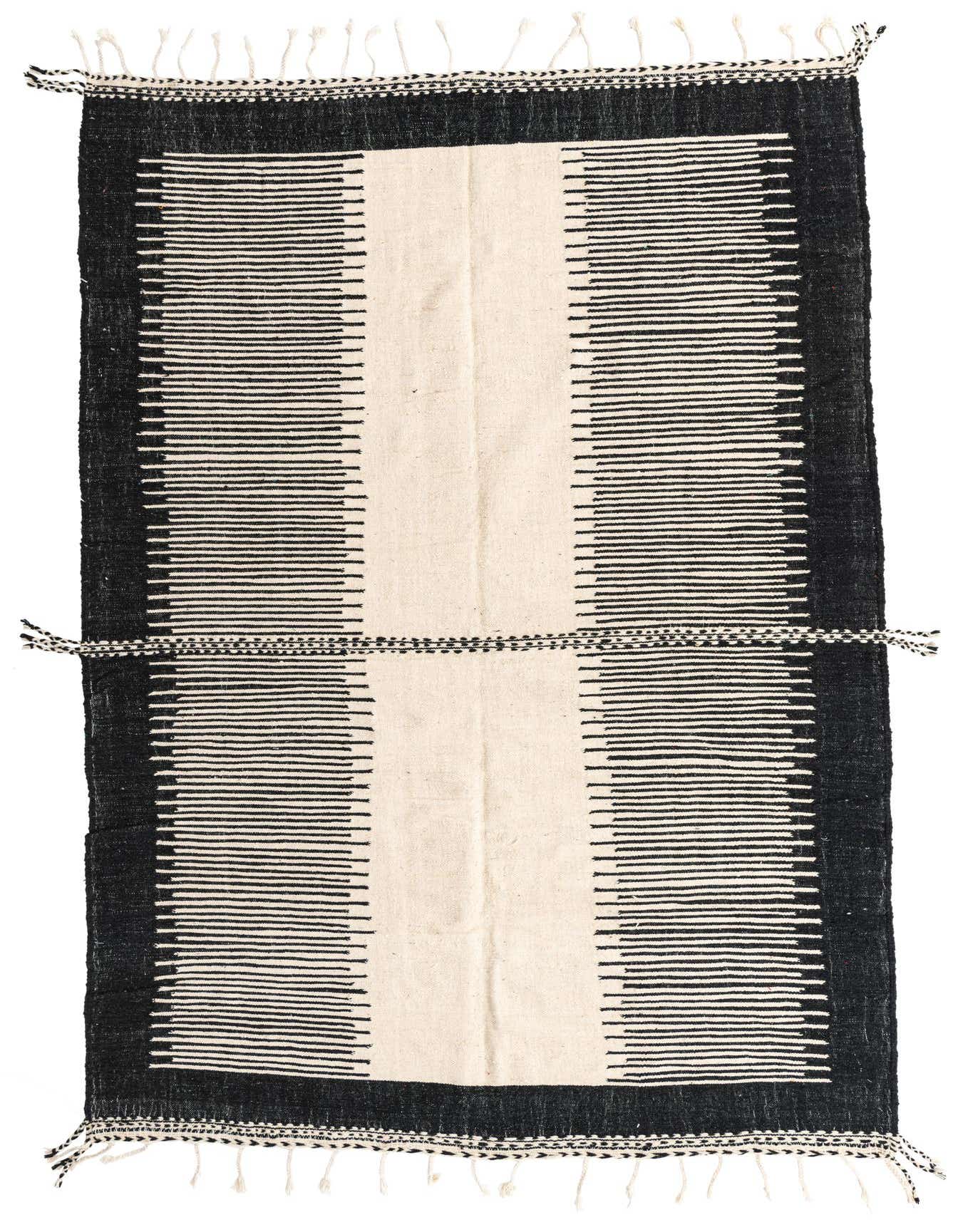 A handmade 8x11 rectangular Moroccan shag rug with a bold black and ivory tribal stripe pattern and tassels.
