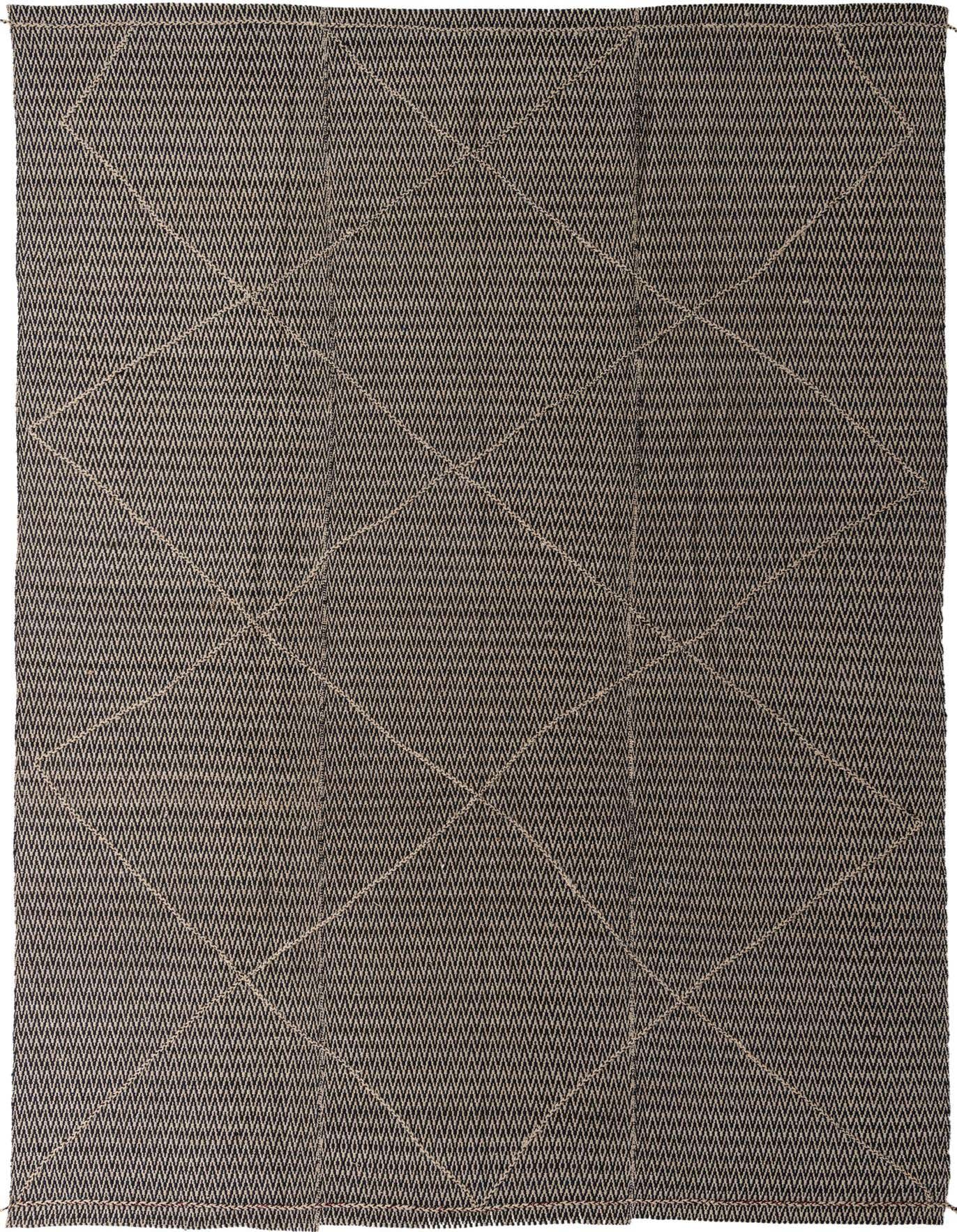 A 10x14 rectangular black and ivory tribal wool shag rug with a modern geometric pattern.