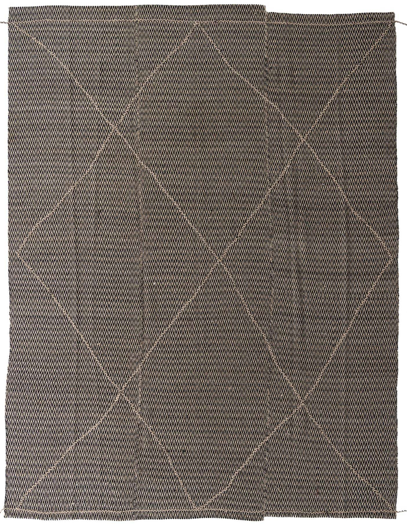 A 10x14 rectangular black and ivory tribal shag rug with an abstract geometric pattern, suitable for indoor use.