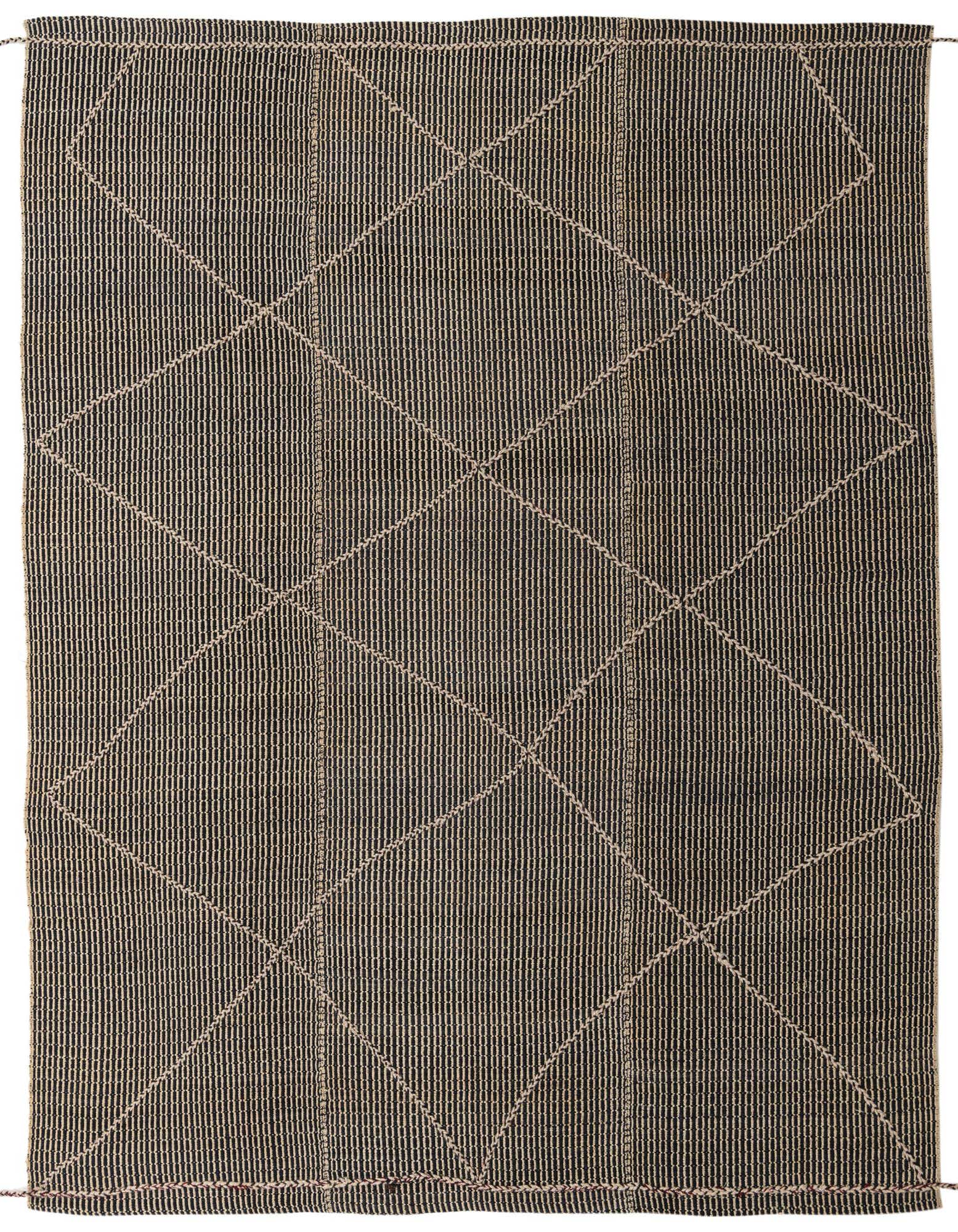 A 9x11 rectangular shag rug featuring a black background with a cream tribal diamond pattern, handmade from wool.