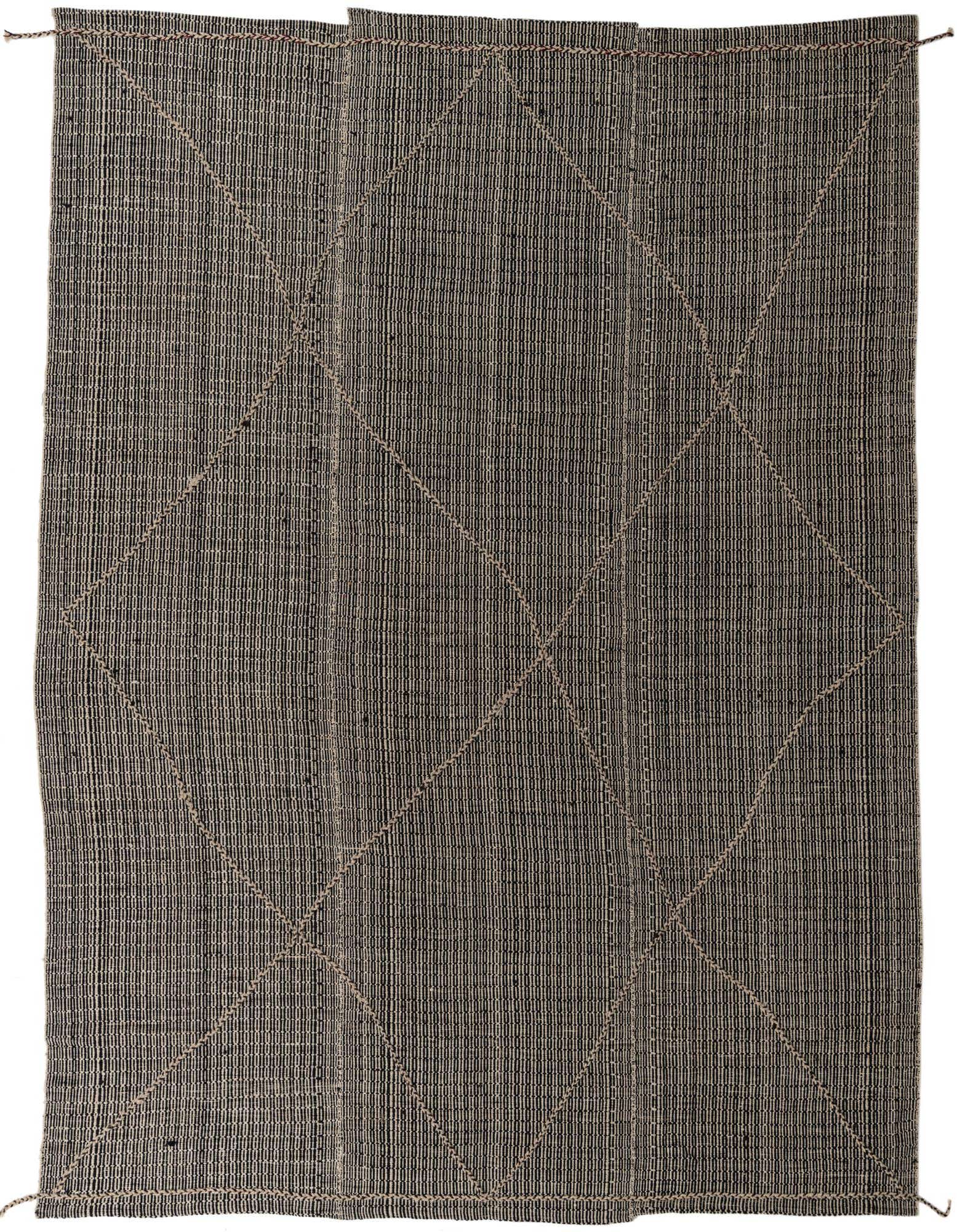 A 9x12 rectangular black and ivory wool shag rug with a subtle tribal diamond pattern, ideal for a living room.