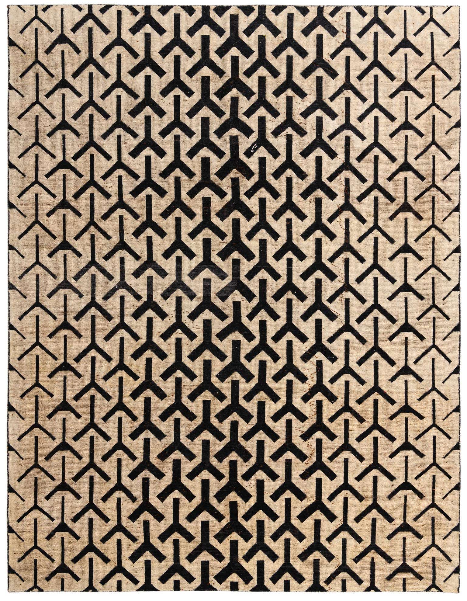 A 9x12 rectangular black and cream wool shag rug with a repeating modern tribal geometric pattern.
