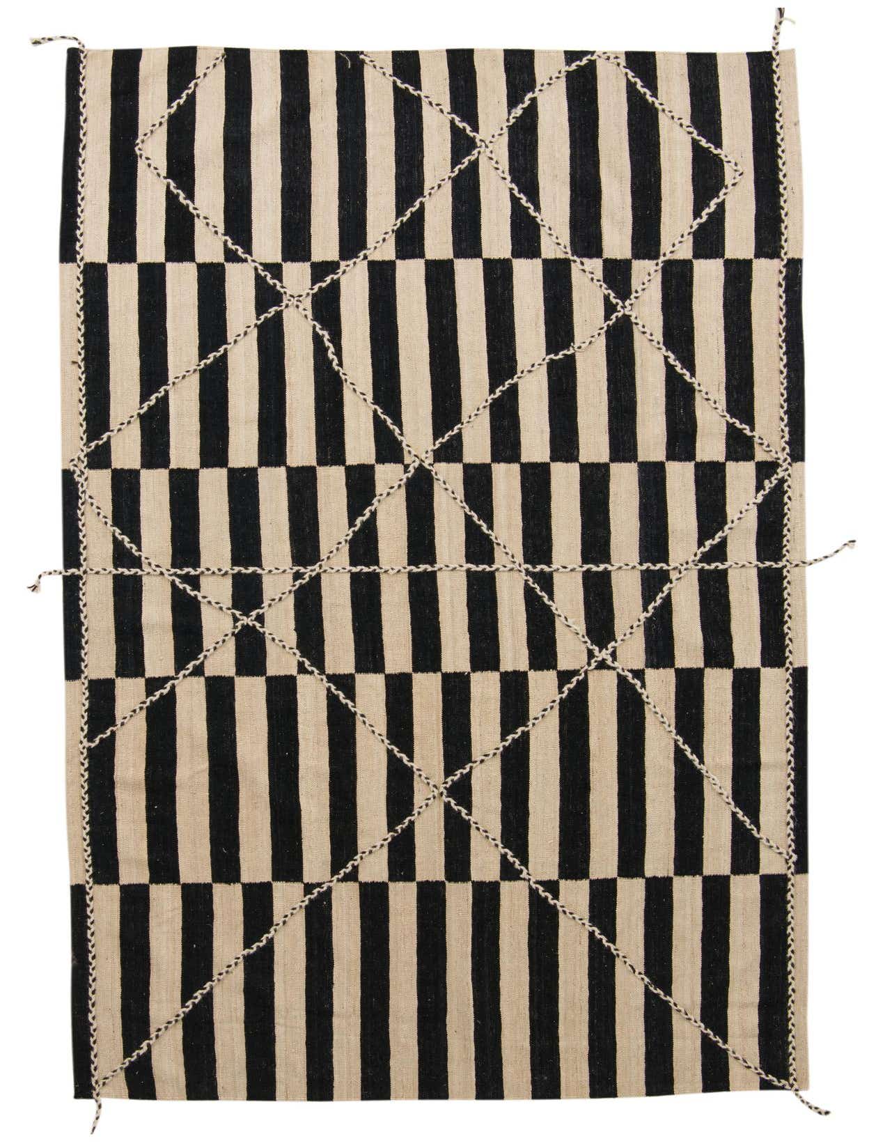 A 6x9 rectangular Moroccan tribal shag rug in black and ivory, featuring bold vertical stripes and a decorative diamond overlay.