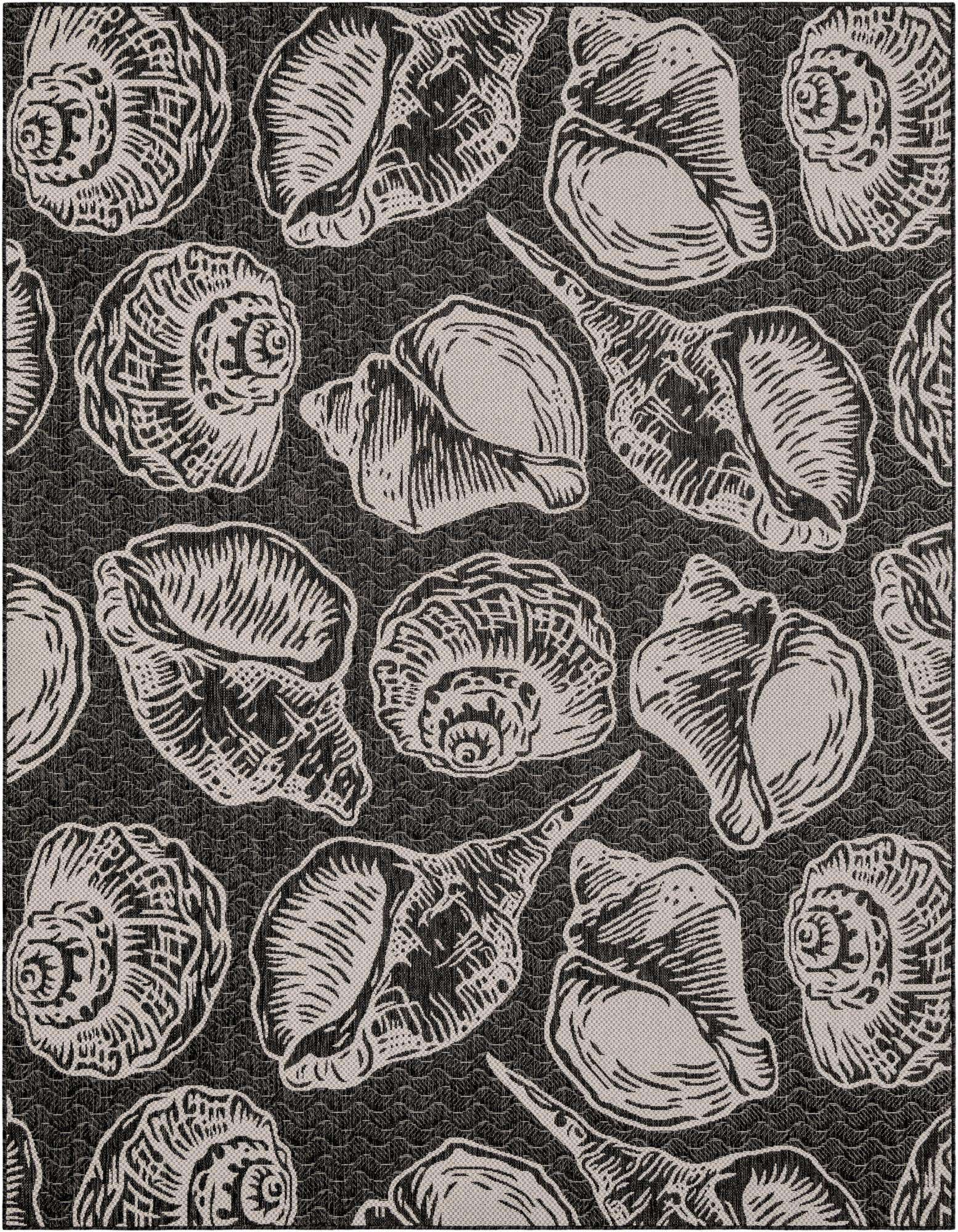 An 8x10 rectangular black and white coastal rug featuring various seashell patterns, ideal for a patio or living room.