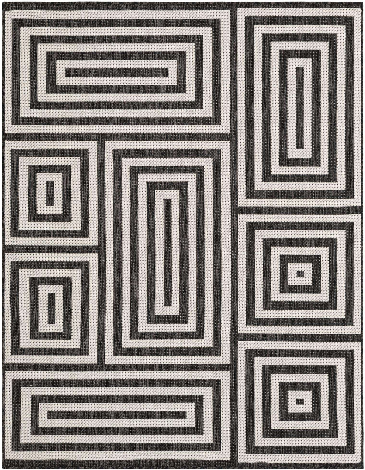 A 5x7 rectangular black and white modern rug with an abstract geometric pattern of interlocking rectangles, suitable for indoor or outdoor use.
