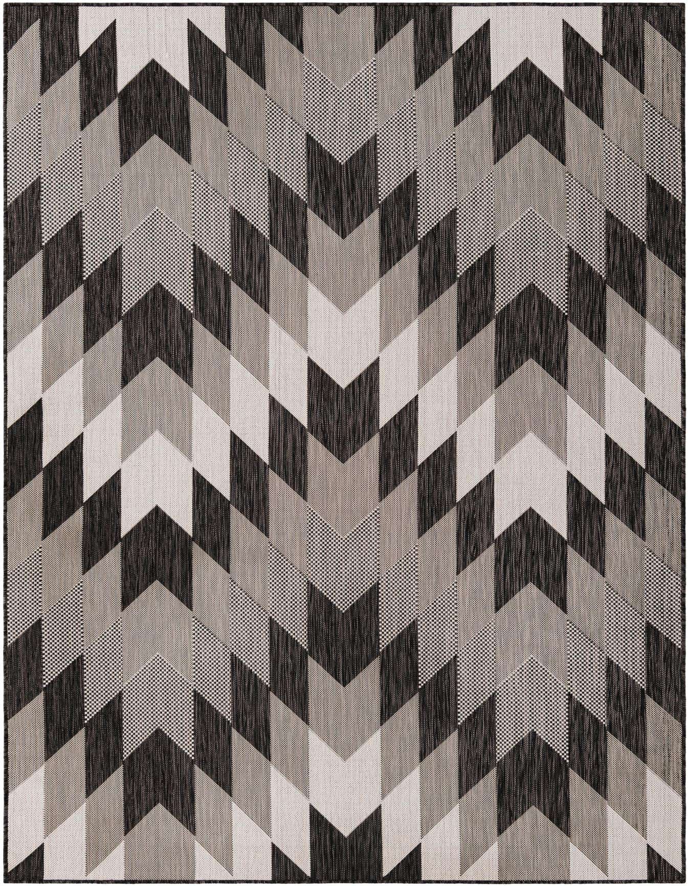 A 6x9 rectangular rug featuring a bold geometric chevron pattern in black, charcoal, and ivory, suitable for indoor or outdoor spaces.