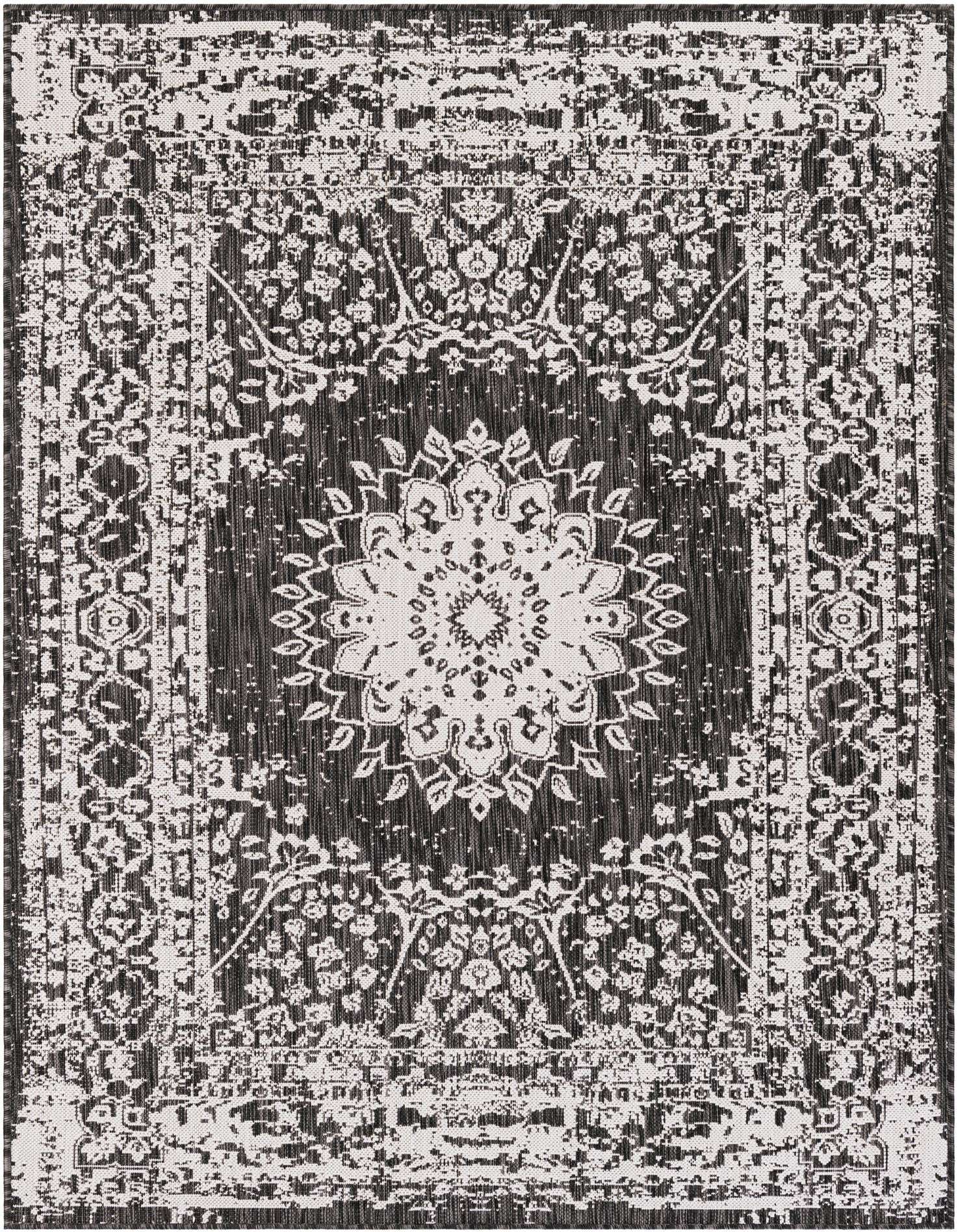 A 5x7 rectangular black and white outdoor rug featuring a distressed medallion and traditional floral pattern.