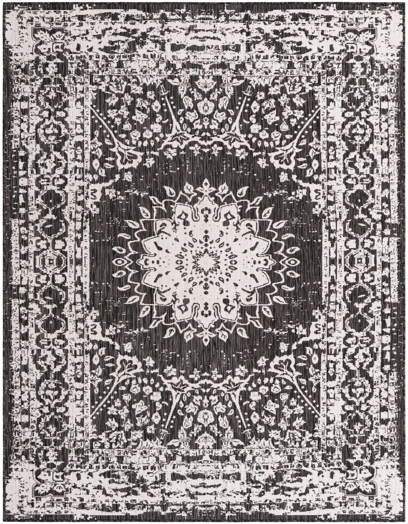 A 6x9 rectangular black and white outdoor rug featuring a distressed medallion and traditional border pattern, suitable for a patio.