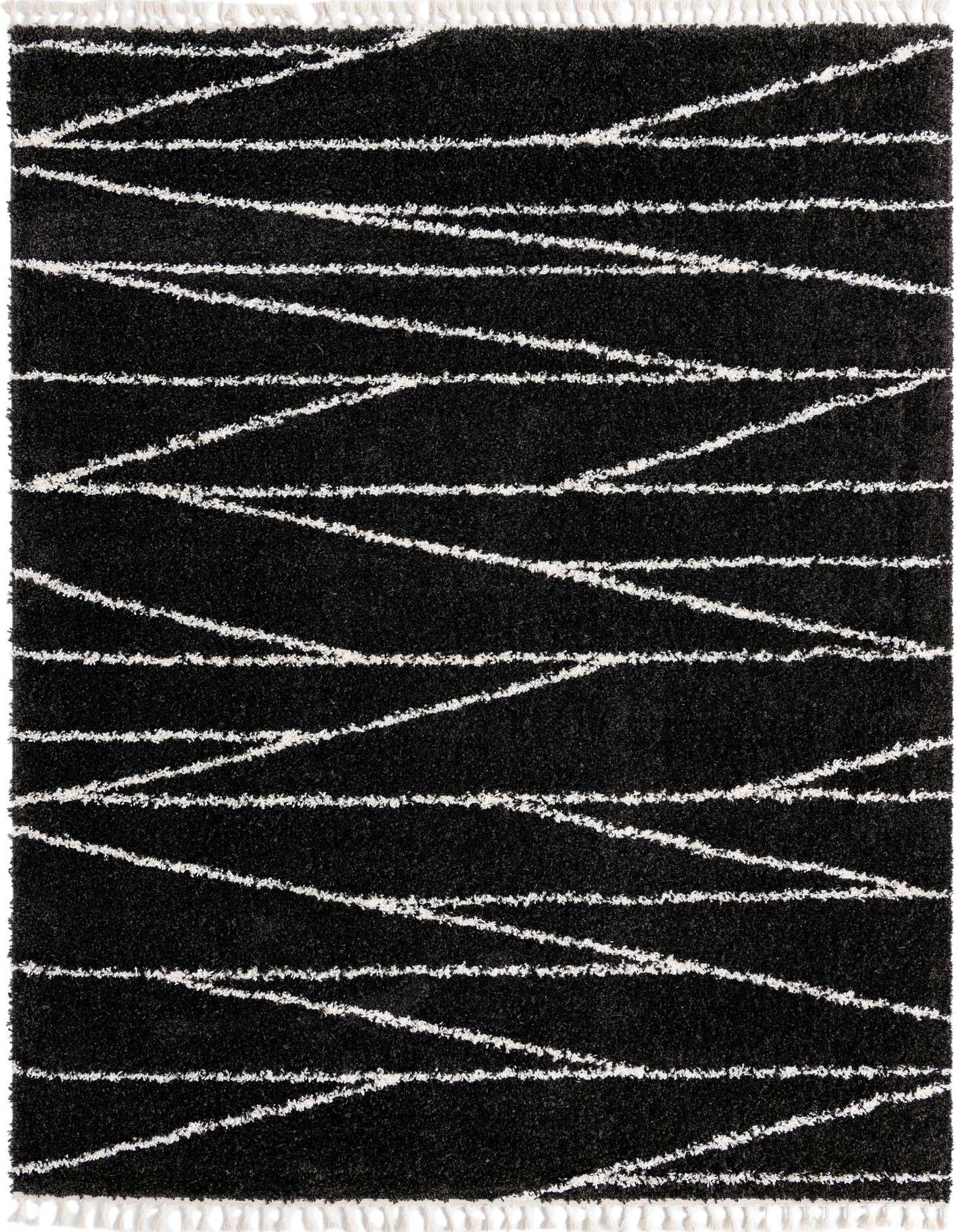 A 9x12 black rectangular shag rug with an abstract white stripe pattern and fringe, perfect for a modern living room.