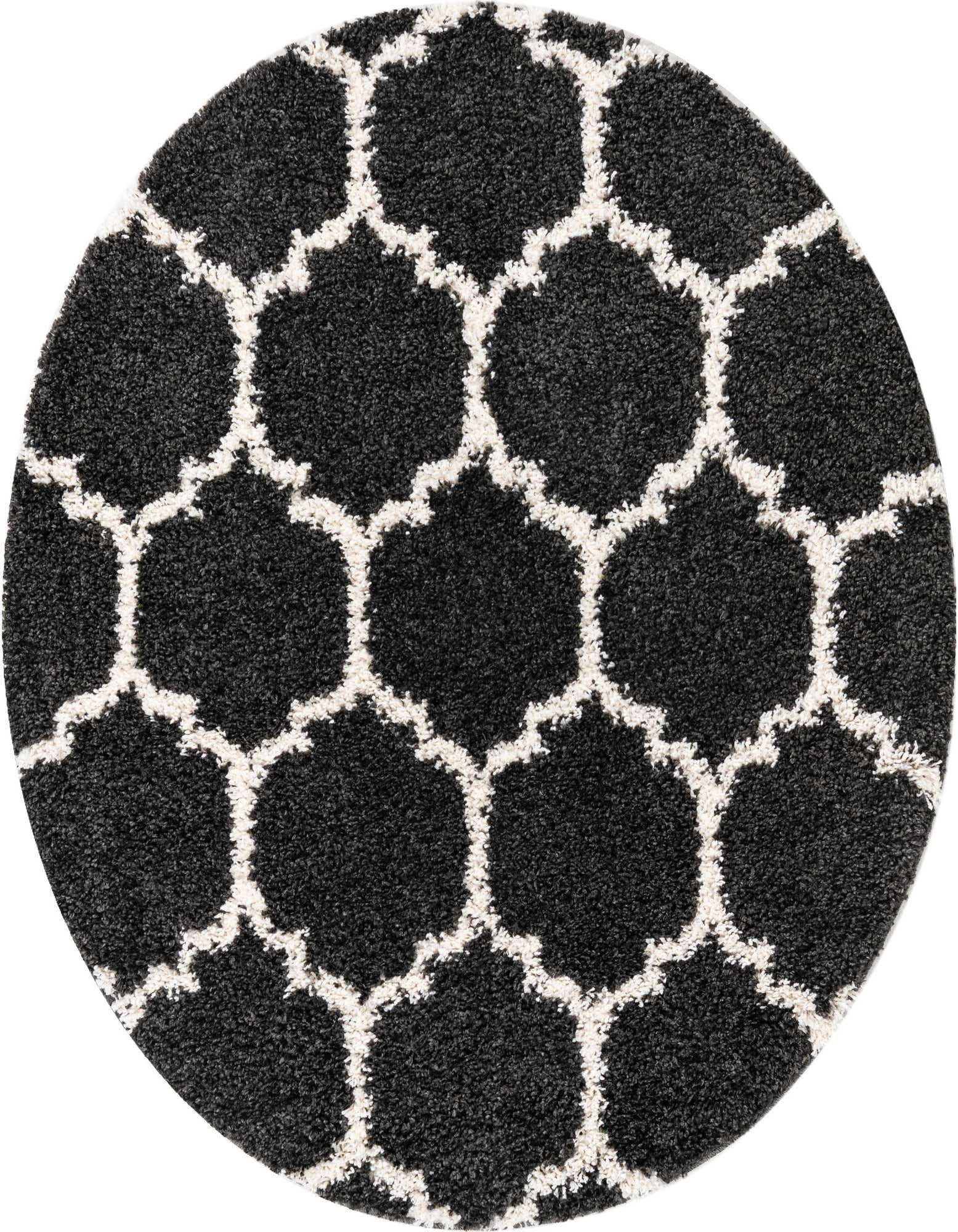 A round 5' 3 x 5' 3 black shag rug with a modern white Moroccan trellis pattern, perfect for a living room.
