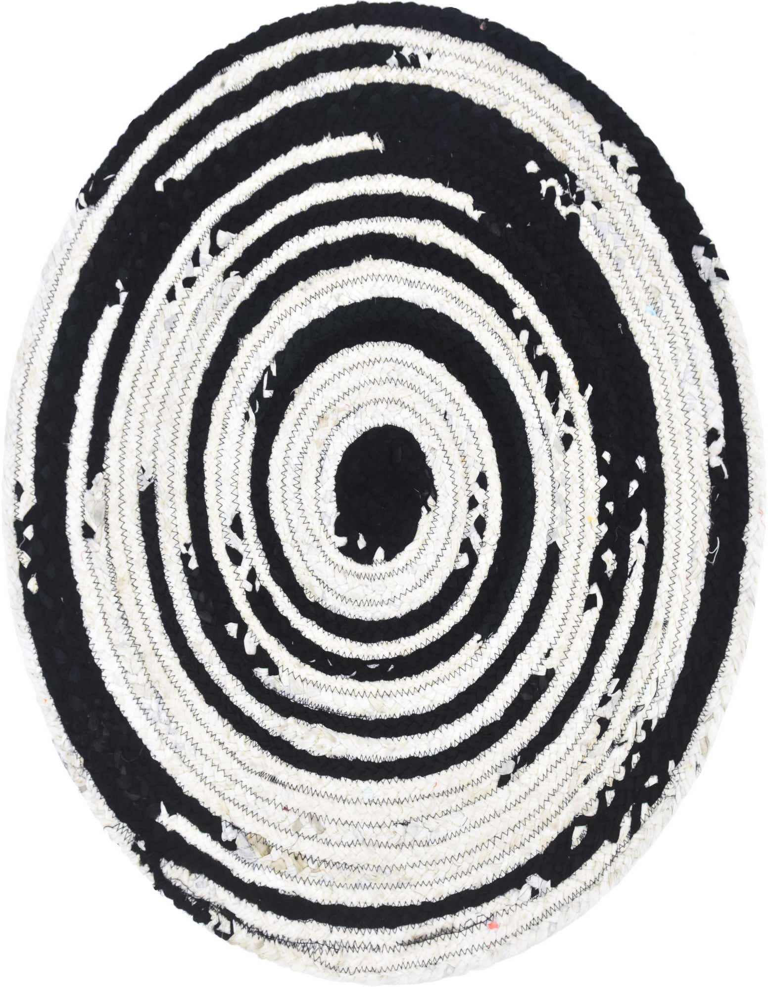 A round black and white braided chindi rug with a spiral pattern, made from recycled cotton.