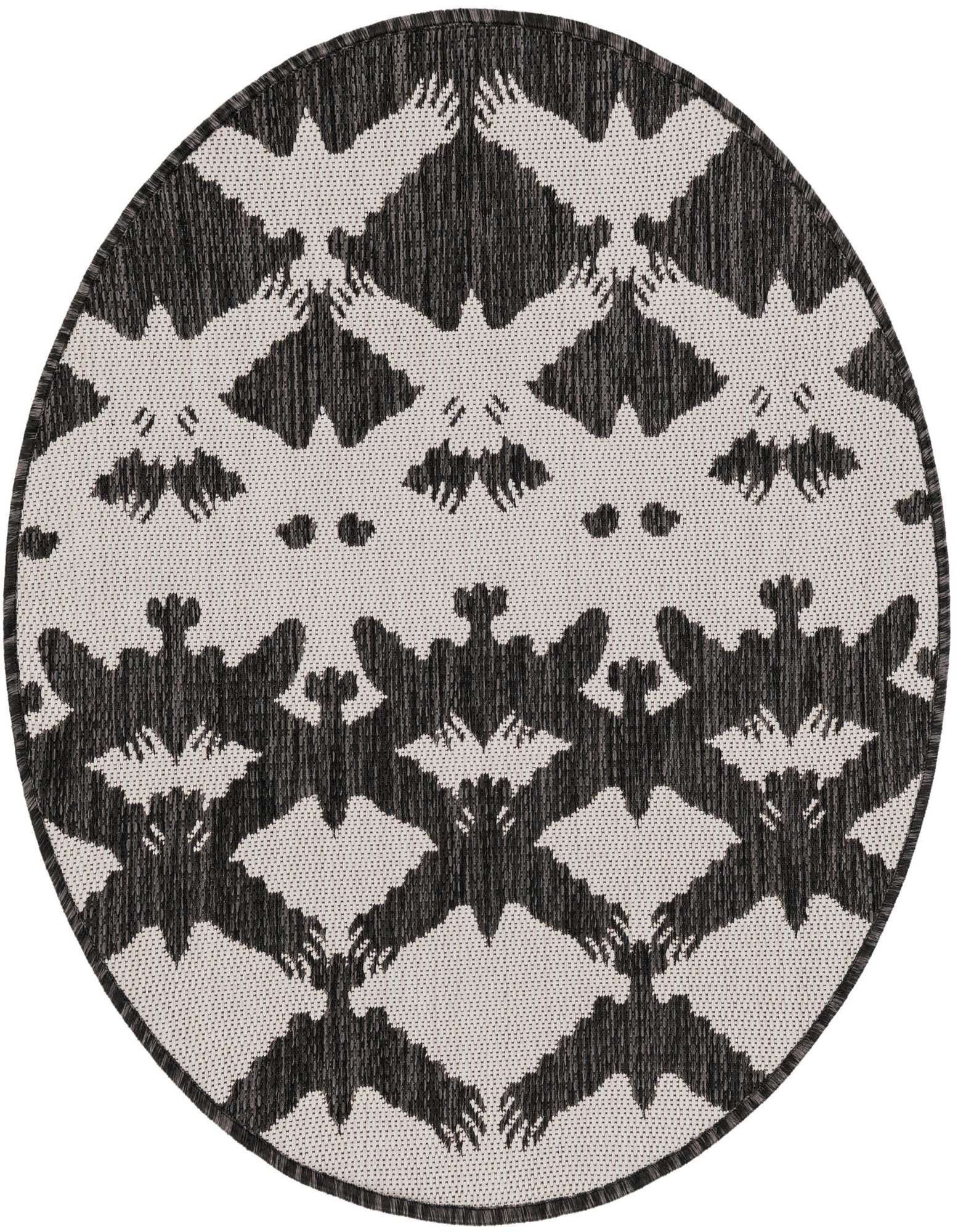 A round black and white modern rug featuring a repeating pattern of stylized bats with outstretched wings, suitable for indoor or outdoor use.