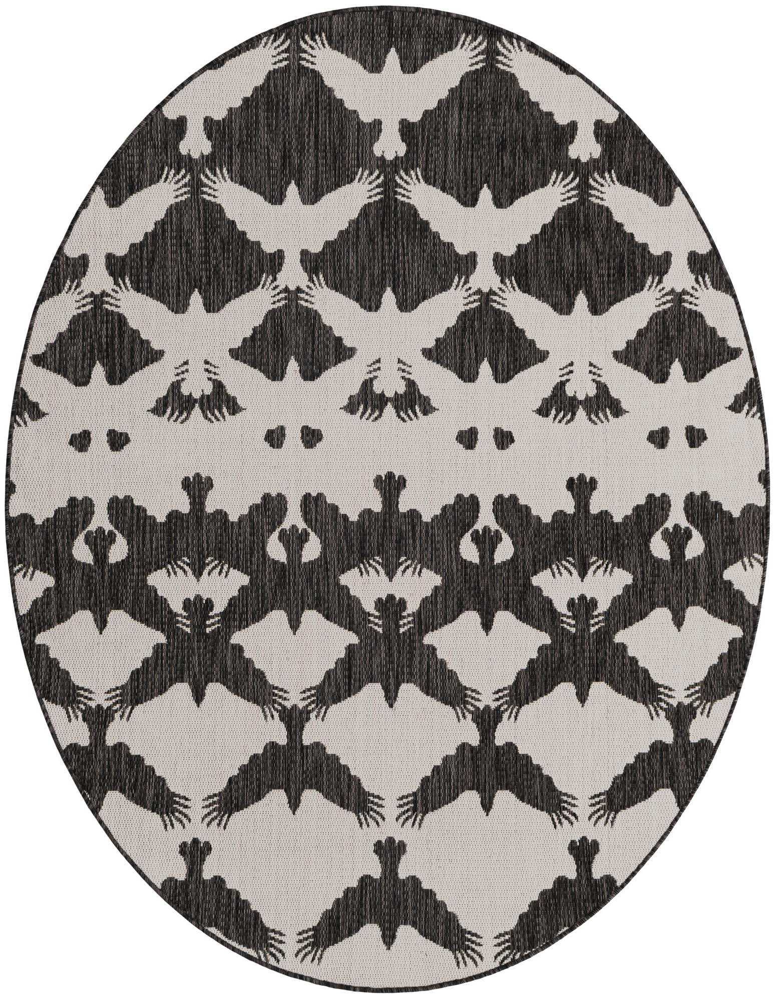 A round, black and ivory modern rug featuring a repeating pattern of stylized flying bats, suitable for indoor or outdoor use.