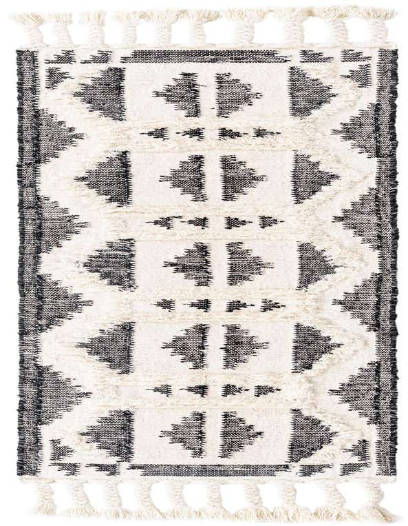 A 6 ft runner rug with a tribal pattern in black and ivory, featuring shag texture and braided tassels.
