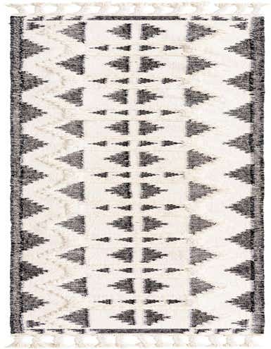 A 13 ft runner rug with a black and white tribal pattern, featuring shag texture and decorative tassels.