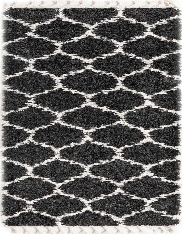 A black and white modern shag runner rug with a geometric trellis pattern and fringed ends, ideal for a hallway.
