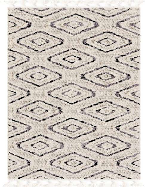 A black and white tribal runner rug with a modern trellis pattern, featuring a high, textured pile and decorative tassels.