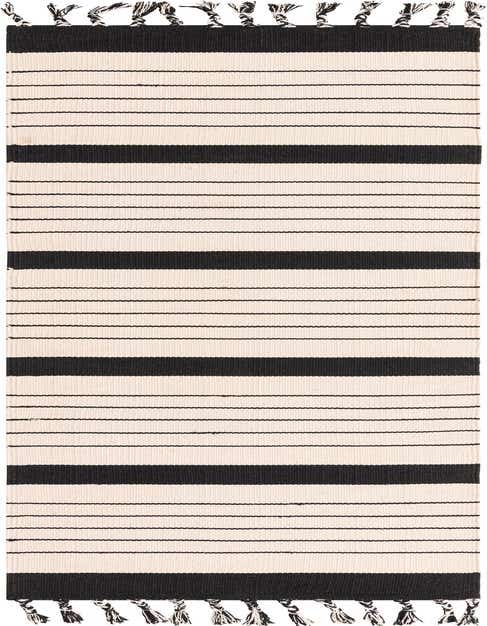 A 10 ft runner rug featuring bold black and white stripes with fringed ends, ideal for a modern hallway.