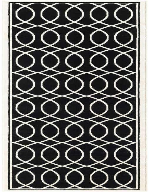 A black and white 8 ft runner rug with an interlocking geometric pattern, perfect for a hallway.