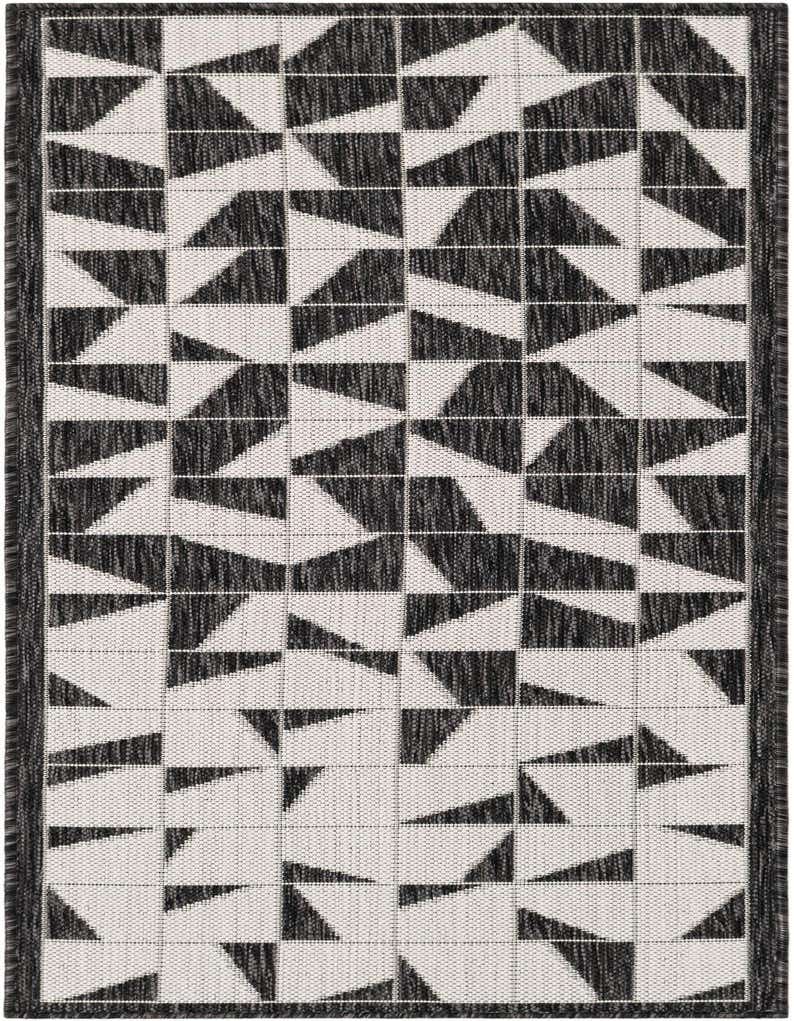 A black and white modern runner rug featuring an abstract geometric pattern of interlocking triangles and squares, ideal for a hallway or patio.