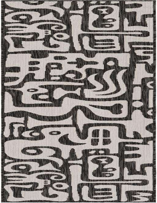 A black and white modern abstract runner rug with bold, organic shapes, perfect for a hallway or patio.