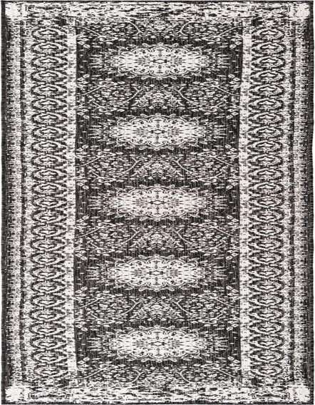 A 12 ft runner rug with a distressed black and white medallion and floral traditional pattern, suitable for hallways or patios.