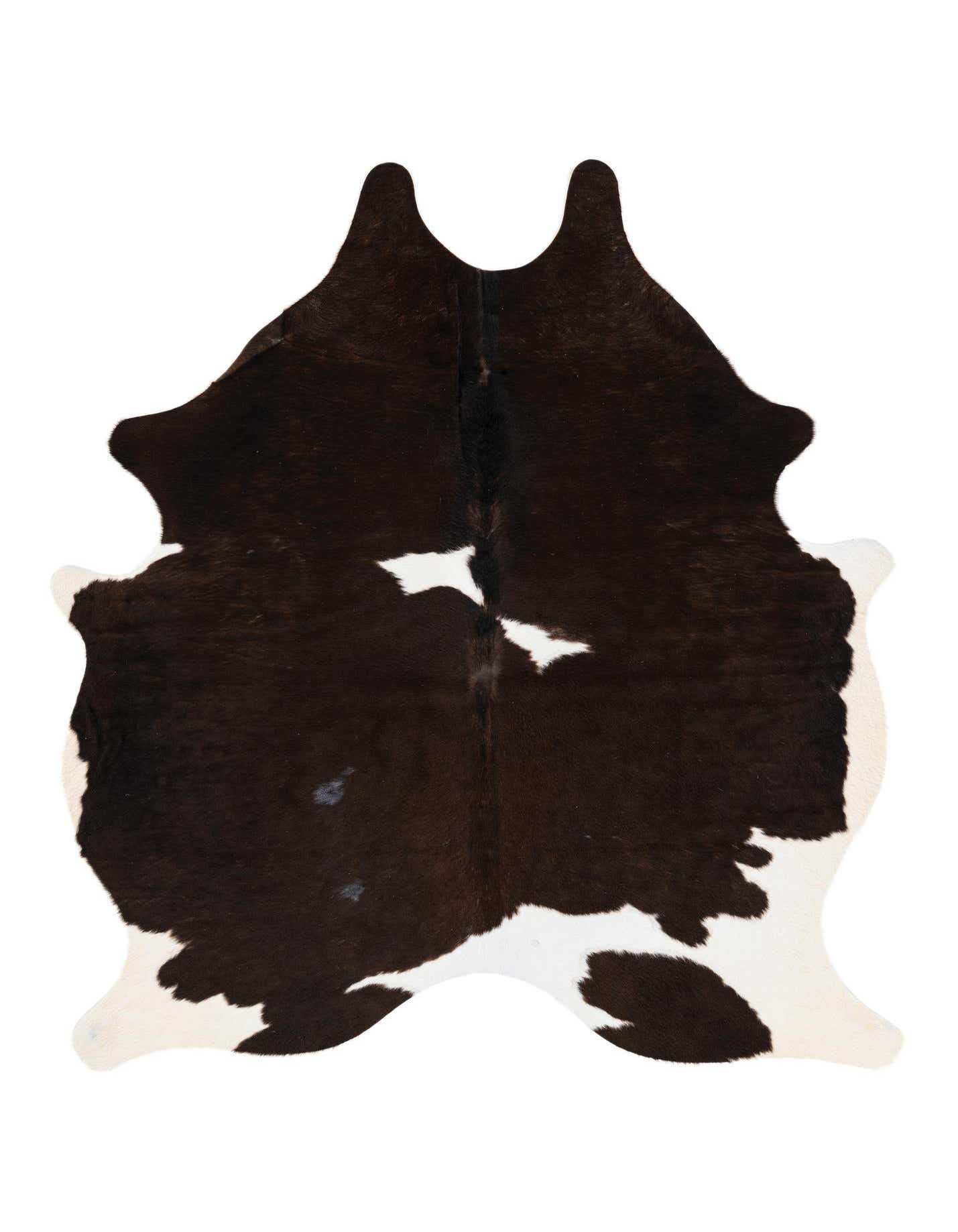 A 4'10" x 5'7" black and white cowhide rug with an irregular, natural shape, featuring dark brown patches on a creamy white background.