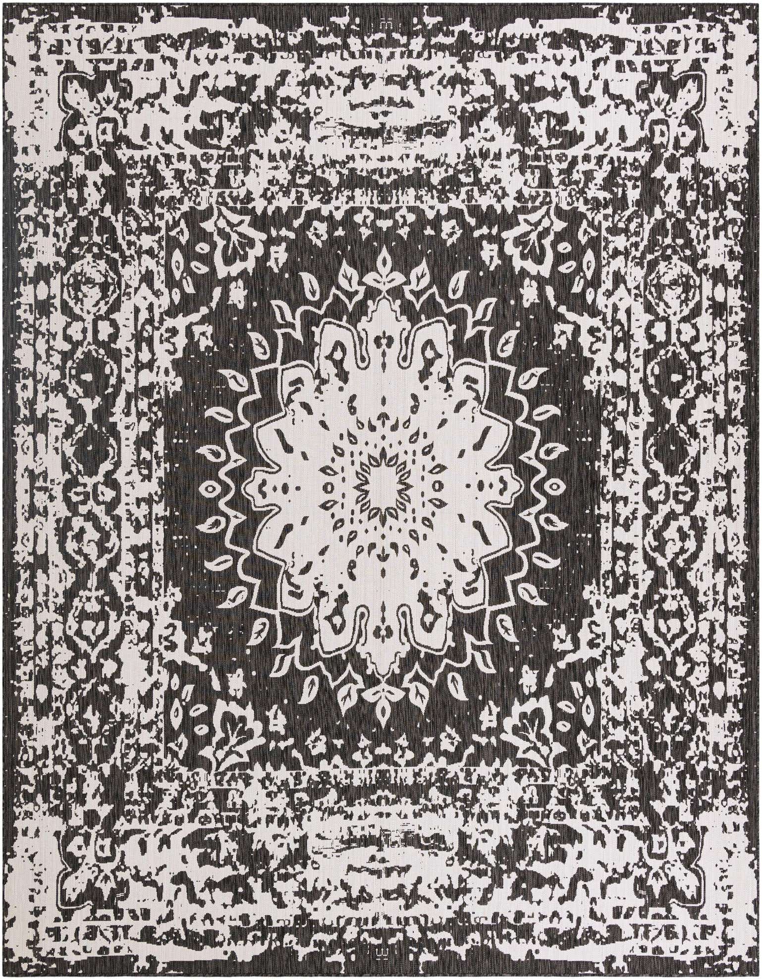 A 12' square black and white outdoor rug featuring a distressed traditional medallion pattern, ideal for a patio.
